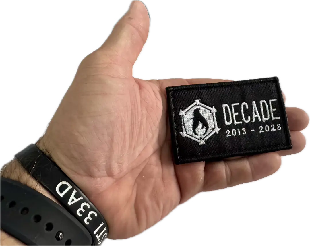 Recycled Firefighter Decade Patch with embroidered design, featuring bold lettering and vibrant colors on a fabric background.