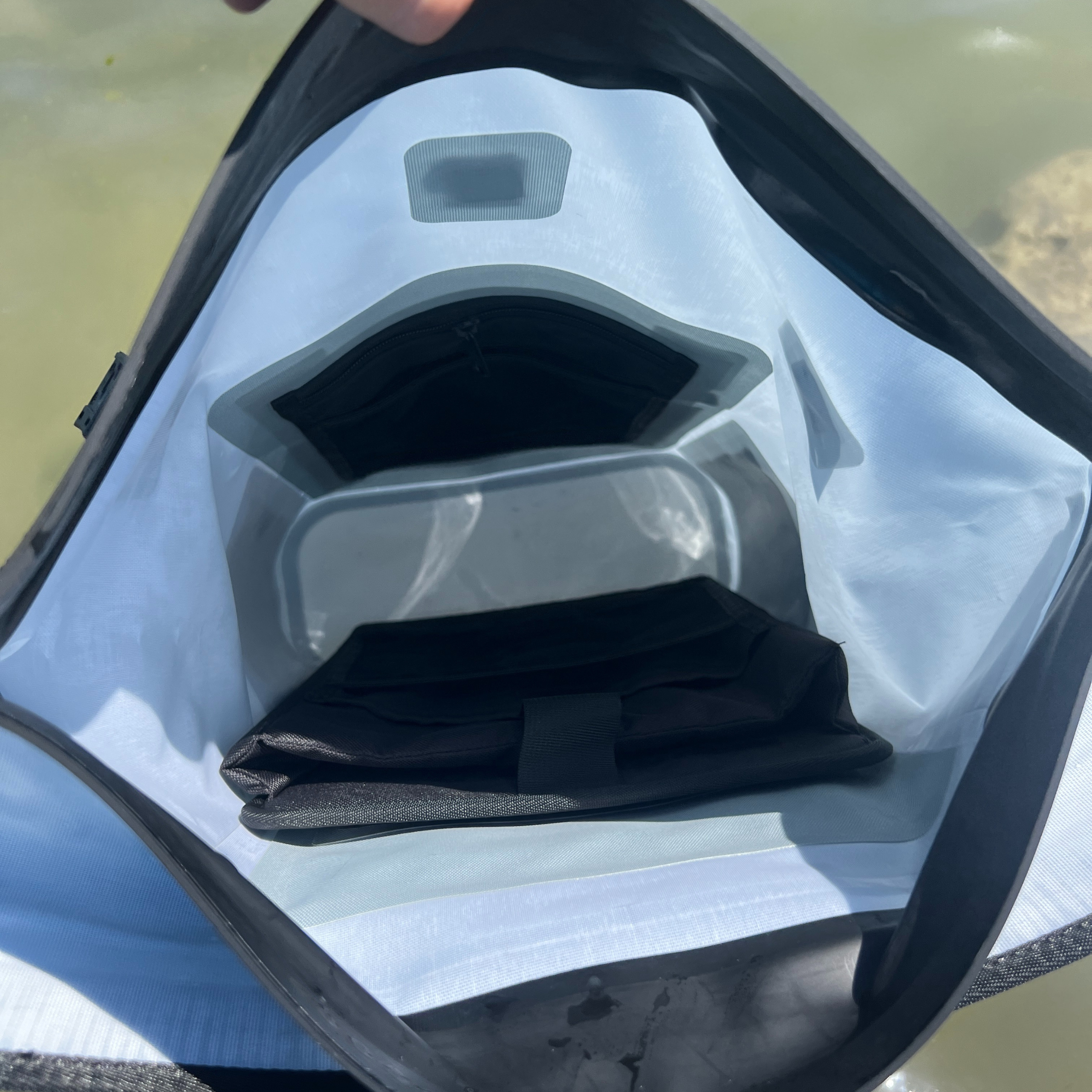 Dry Pocket waterproof floating dry bag with magnetic auto-sealing closure in desert sage color, designed for outdoor waterproof storage.