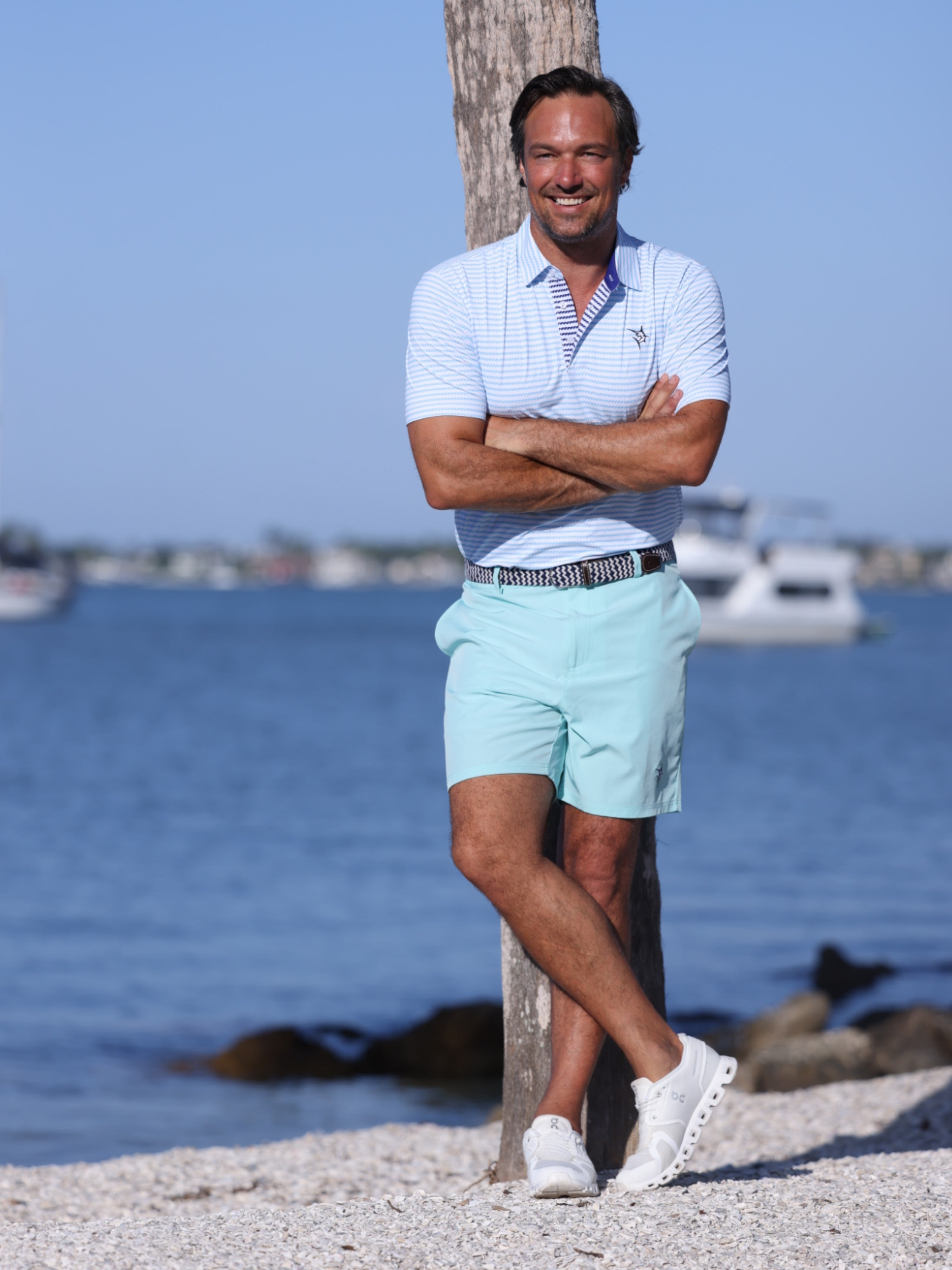White Water Life Freeport Short Effortless Performance shorts in aqua color, displayed on a dockline background.