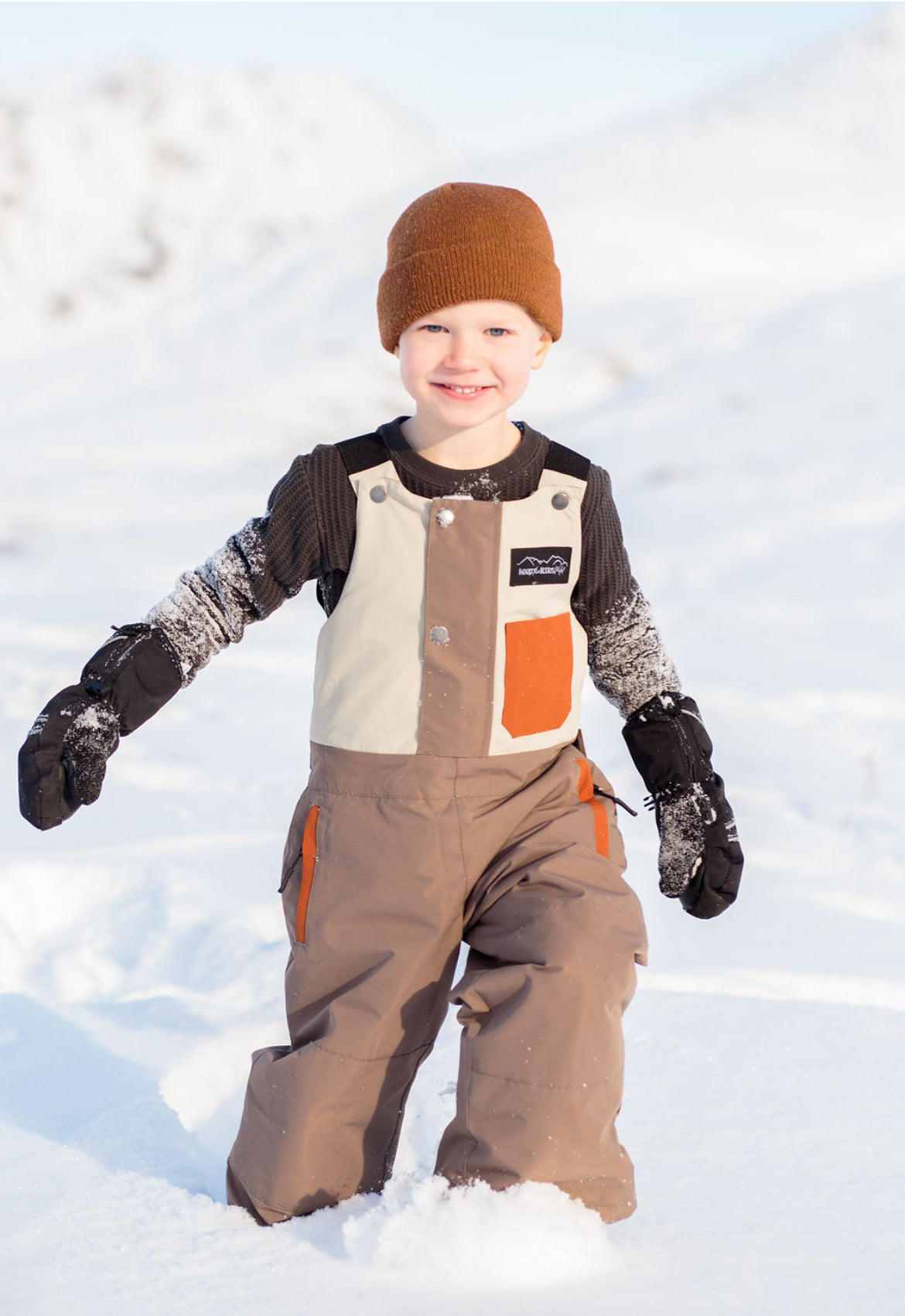 Waterproof snow bib for youth and toddlers by Keep the Littles Wild, showing insulated, colorful winter snow bib with adjustable straps.