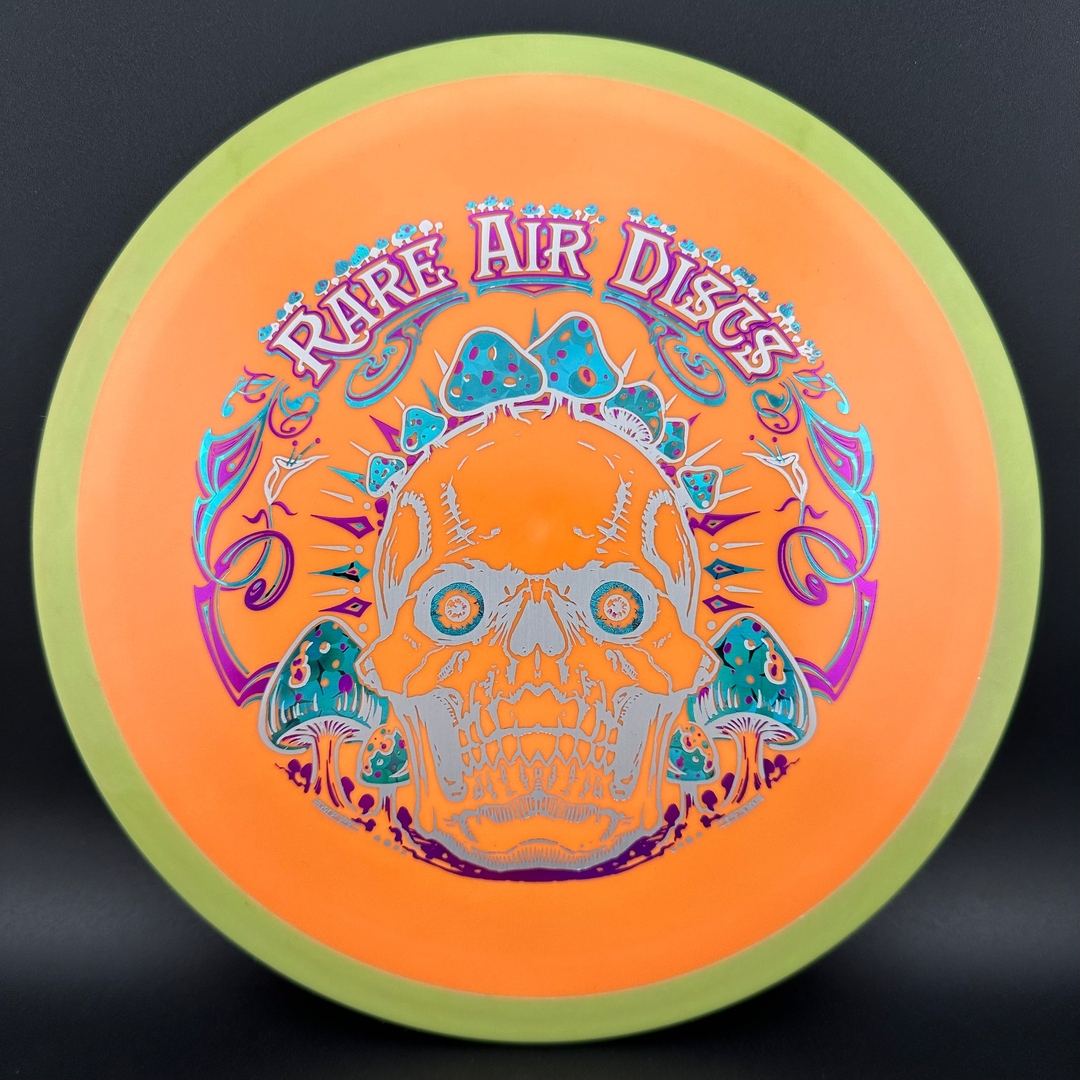 Rare Air Discs Fission Defy Crushin' Amanitas VIP 2.0 disc golf disc with vibrant design and durable plastic in a close-up shot.