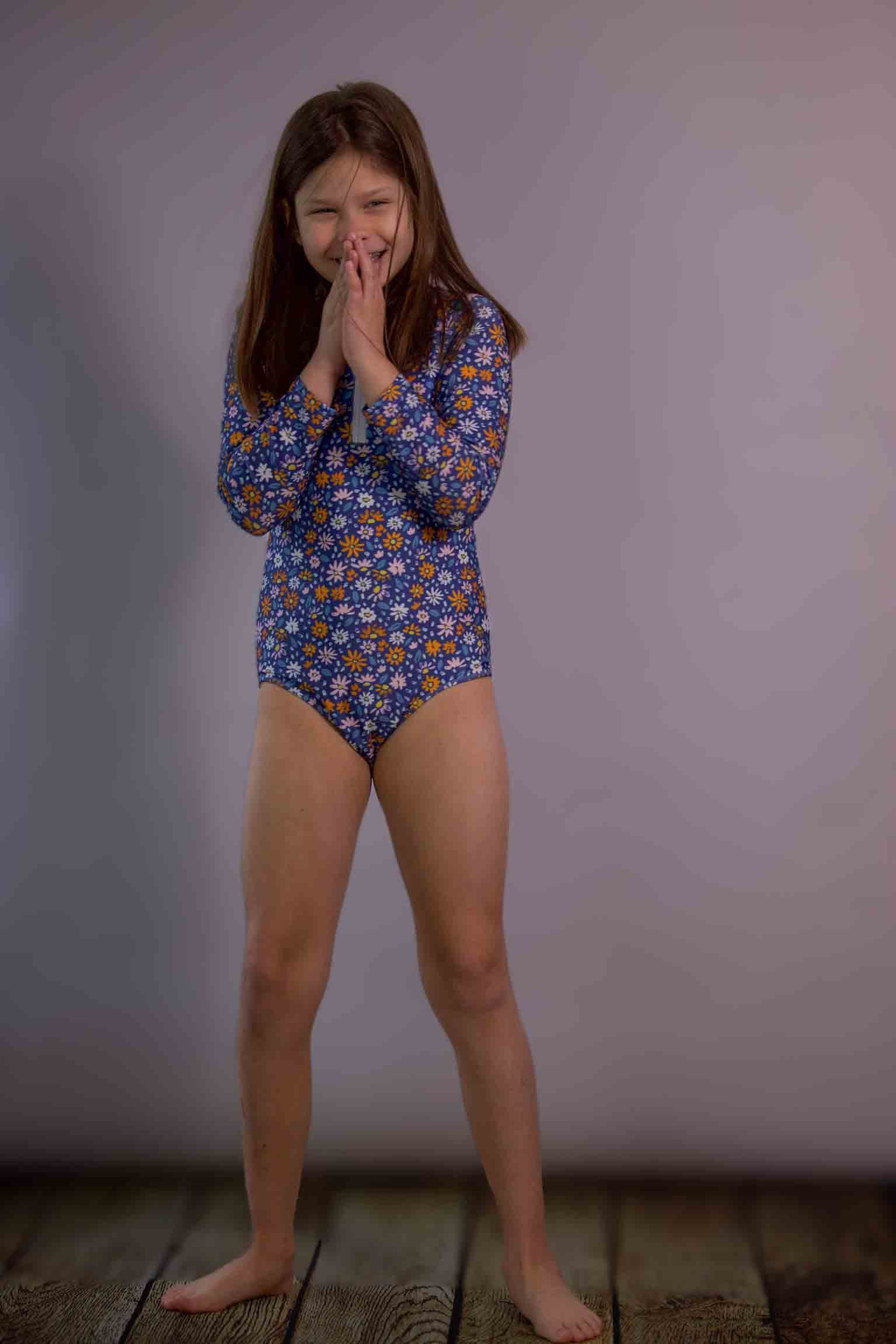 Keep the Littles Wild flowers swimsuit featuring a colorful floral pattern on a stylish one-piece swimsuit.