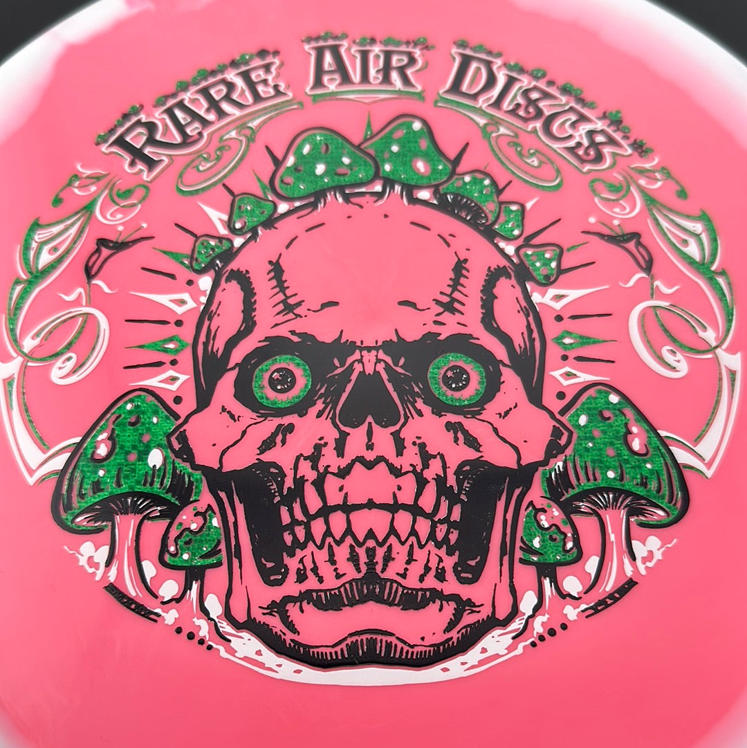 Rare Air Discs Halo S-Blend Tomb Crushin' Amanitas disc golf stamp by Manny Trujillo on a disc with colorful design.