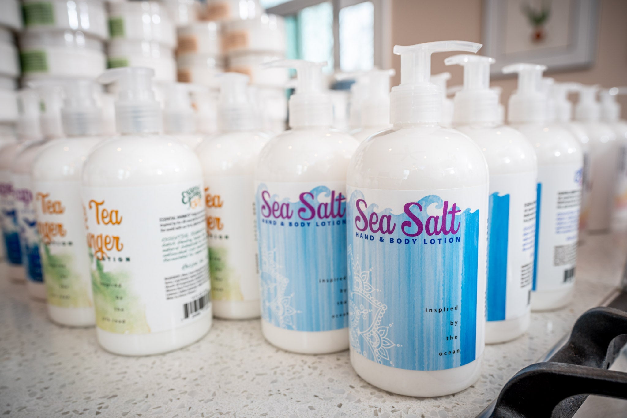 Essential Journeys sea salt hand and body lotion in a 16 oz or 2 oz jar, featuring natural moisturizing butters and salves.