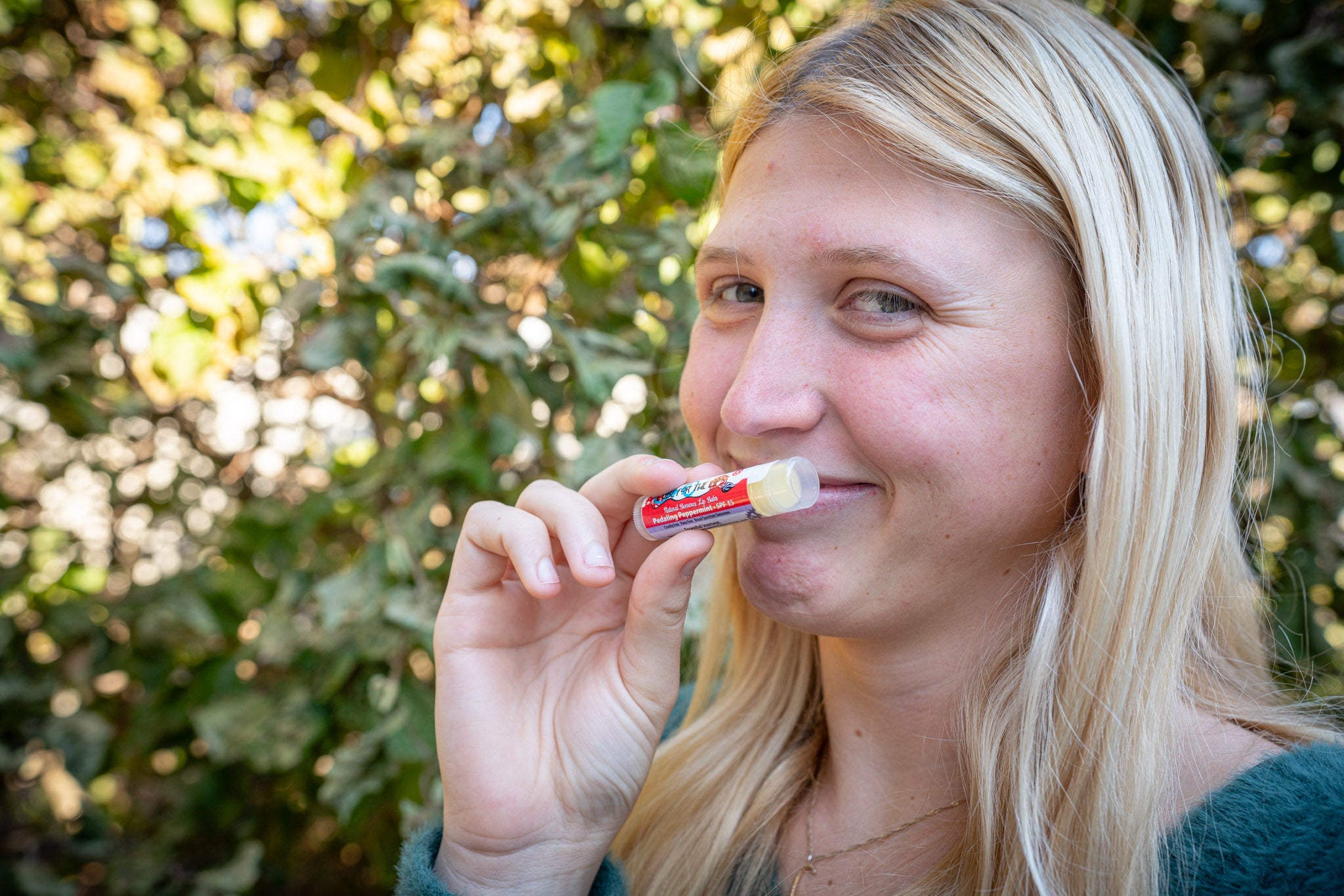 Essential Journeys Pedaling Peppermint SPF 15 Lip Lube, natural lip balm with peppermint scent and SPF protection, shown in the image.