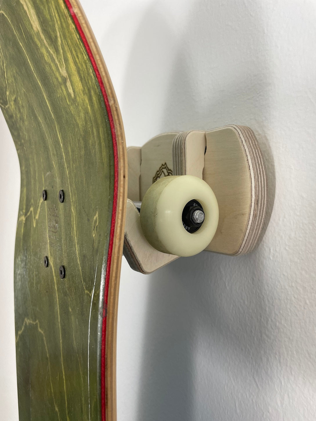 Rado Racks Elevator skateboard and longboard wall rack displaying a mounted skateboard on a sleek black wall mount.