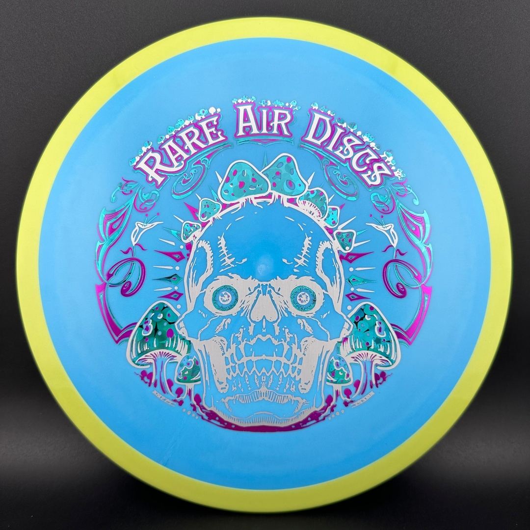 Fission Defy Crushin' Amanitas VIP 2.0 disc golf disc by Rare Air Discs, showing vibrant design and branding on the disc.