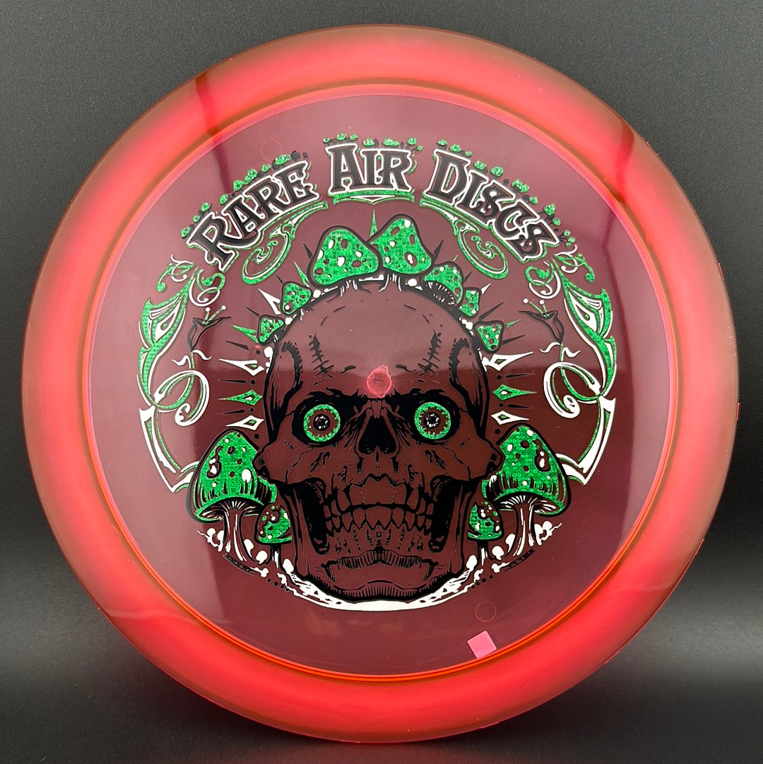 Disc golf stamp by Manny Trujillo on Rare Air Discs Ethos Construct Crushin' Amanitas disc, featuring detailed mushroom artwork.