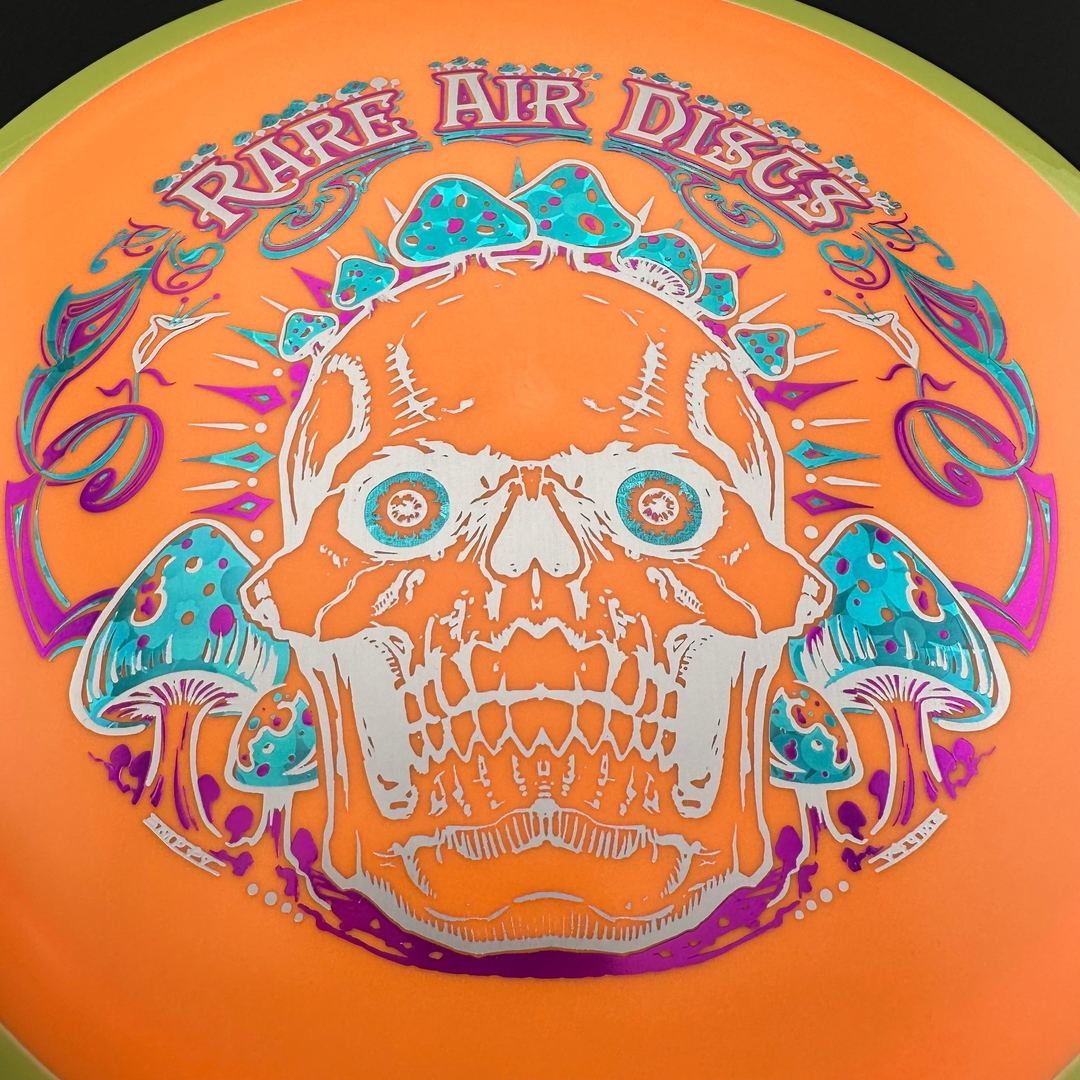 Rare Air Discs Fission Defy Crushin' Amanitas VIP 2.0 disc golf disc with vibrant colorful design and bold branding.
