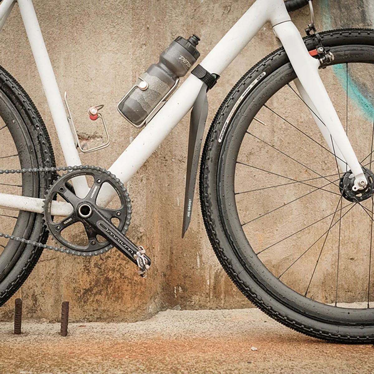 Black ZEITBIKE ASS SAVERS Speed Mullet front mudguard for bikes, shown installed on a bicycle wheel.