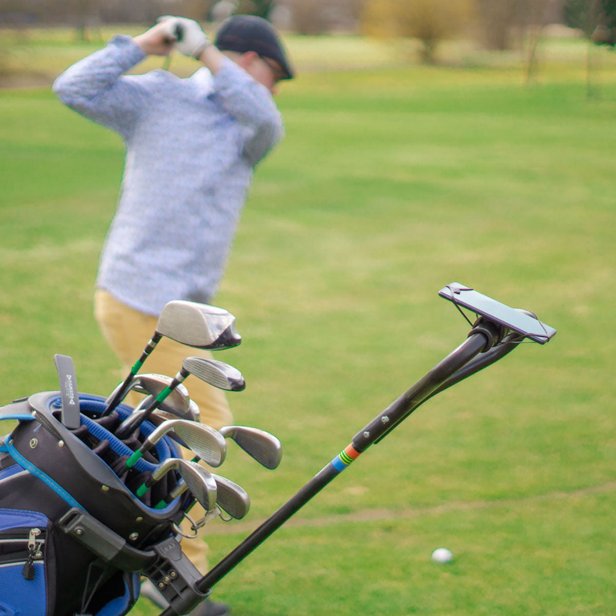 ZEITBIKE FINN universal golf phone mount holder attached to a golf cart, securely holding a smartphone during play.
