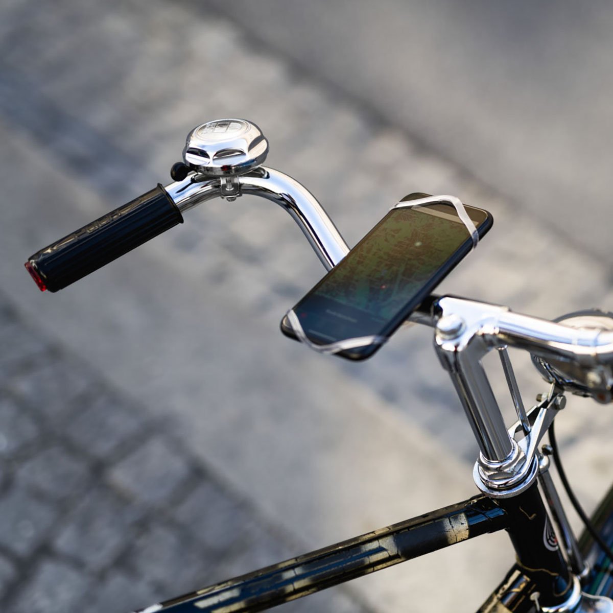 Red ZEITBIKE FINN universal bicycle phone mount attached to a bike handlebar, holding a smartphone securely in place.