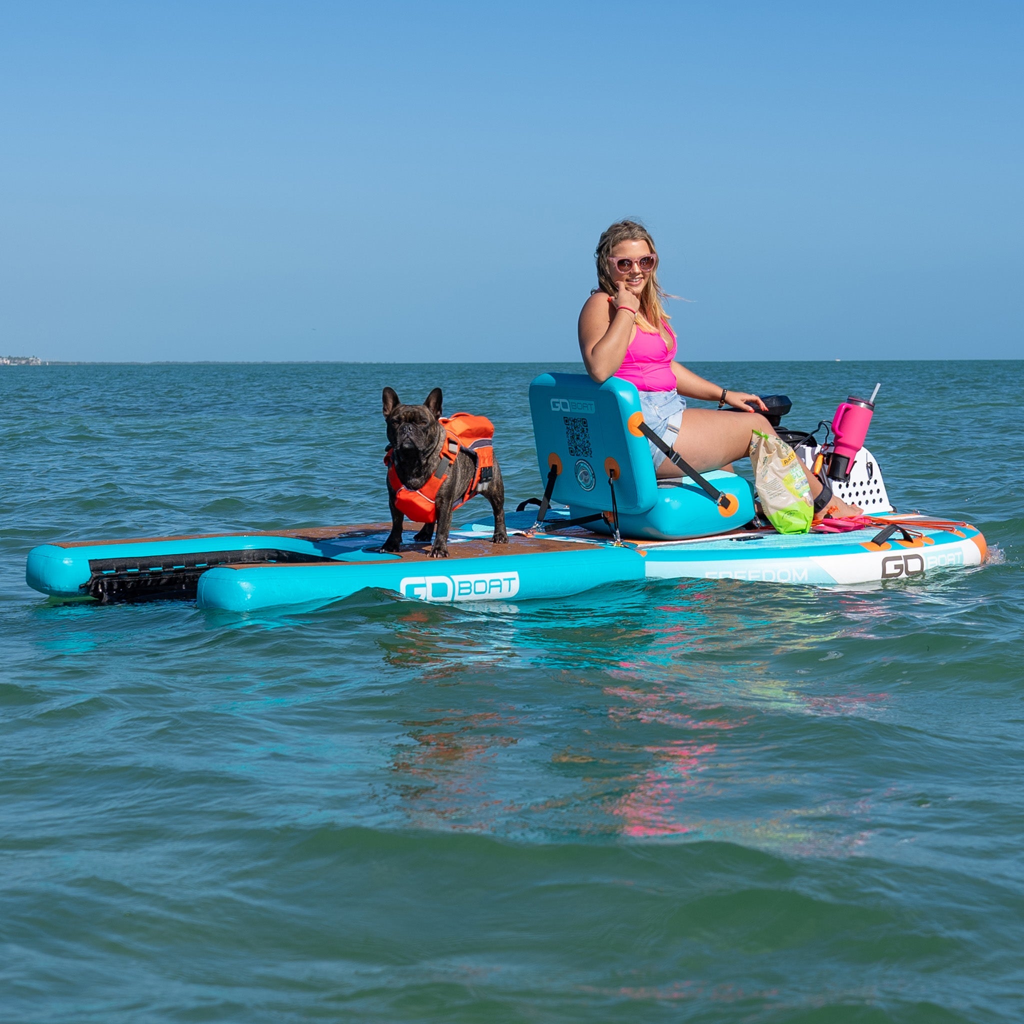 GoBoat Freedom watercraft with a dog on board, showcasing a sleek design and spacious interior for outdoor water adventures.