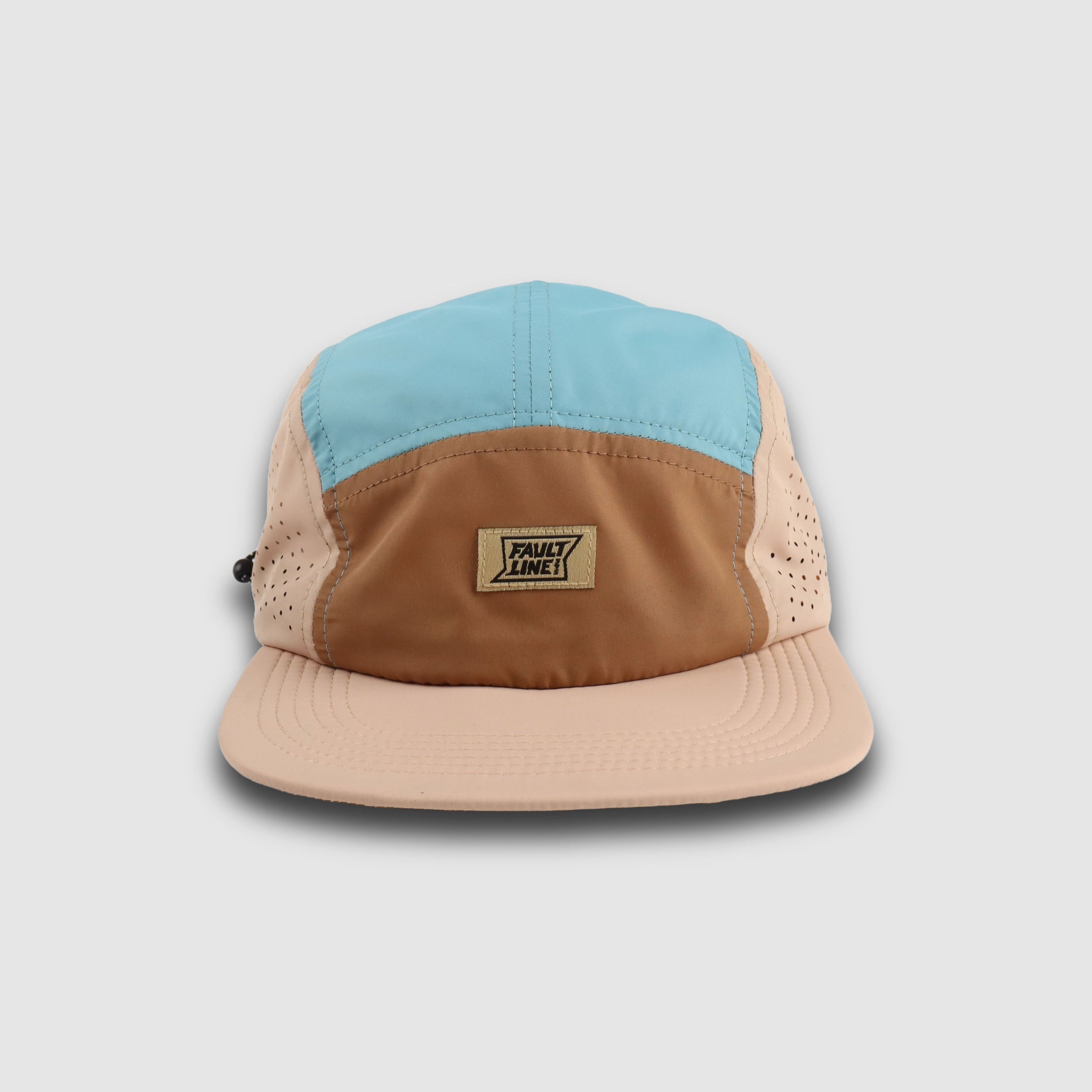 Faultline395 crushable 5-panel camper hat in tan and teal with breathable fabric and adjustable strap, casual outdoor style.