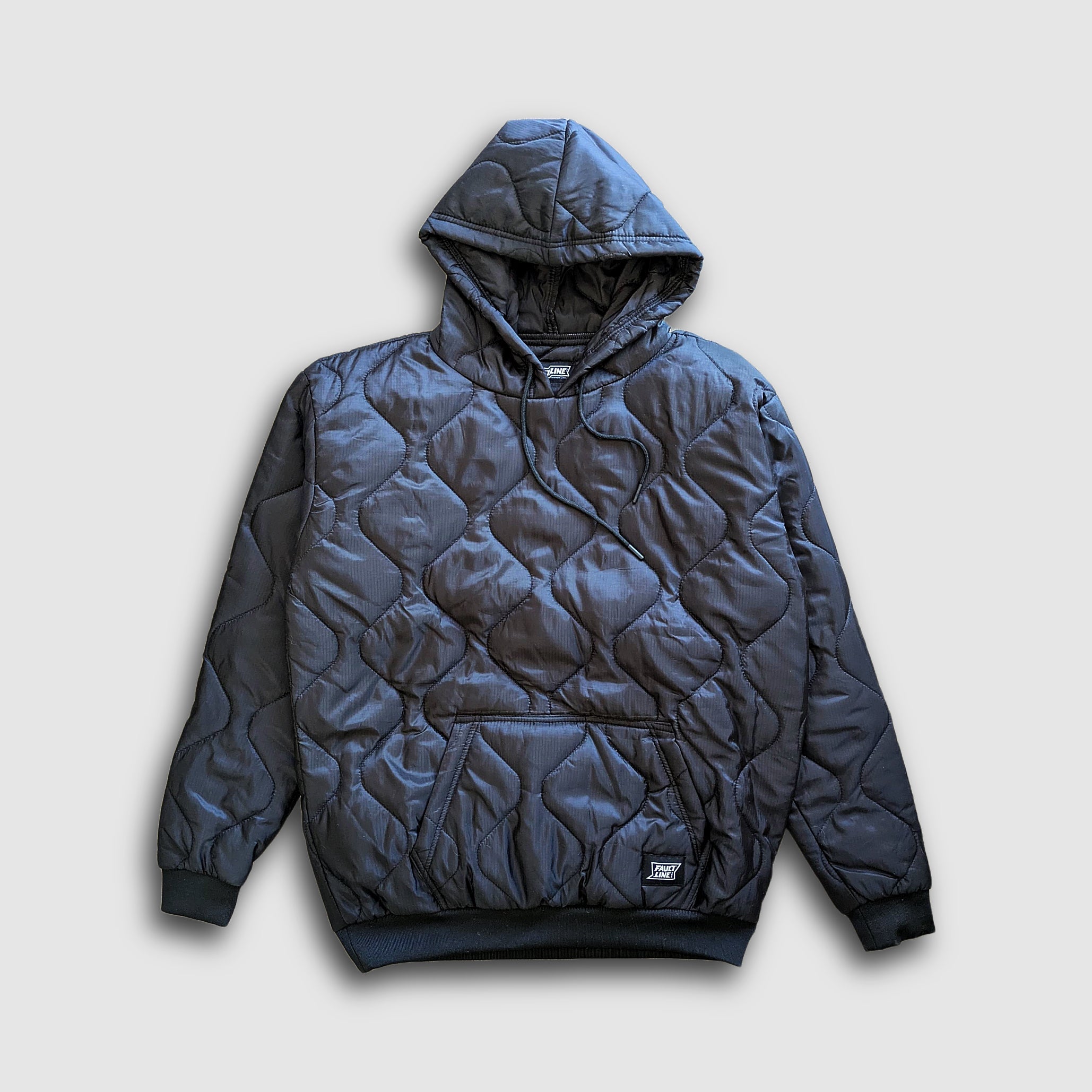 Black Sherwin Puff Hoodie by Faultline395 with a padded, textured design and a hood, shown on a person wearing it.
