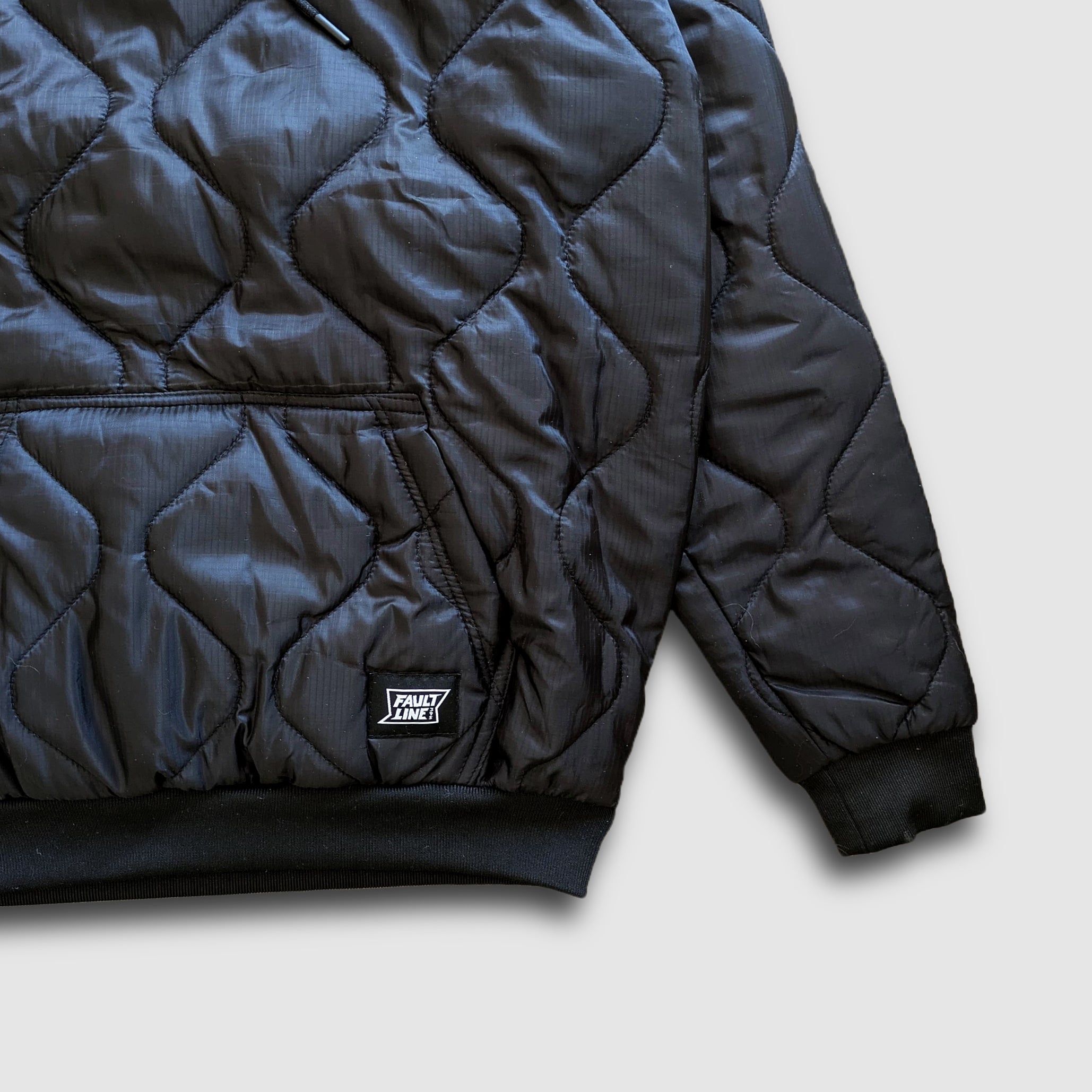 Black Sherwin Puff Hoodie by Faultline395 showing a comfortable, stylish hoodie with a puffed design and front pocket.