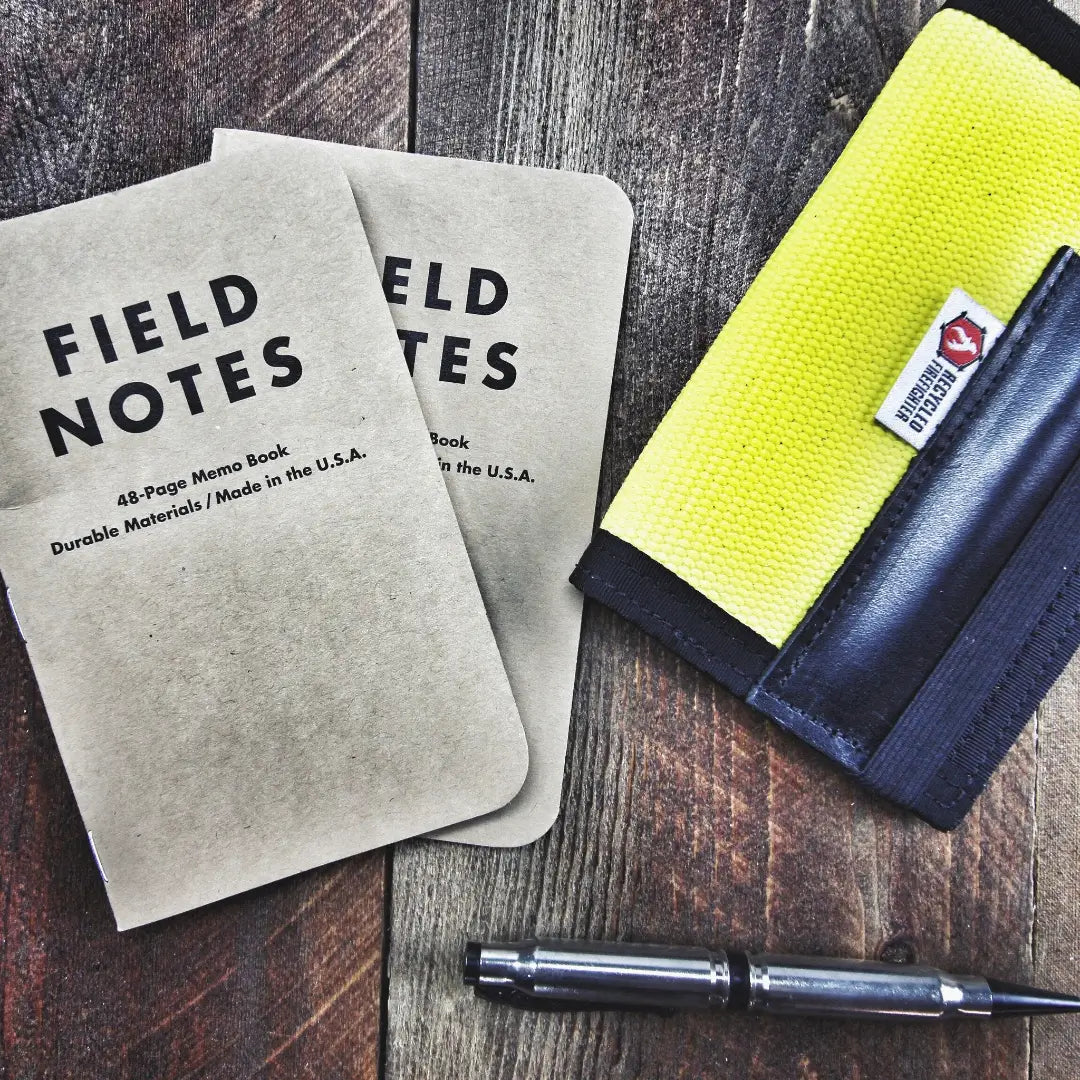 Recycled Firefighter Field Notes notebook with graph paper, featuring a durable cover and compact size for note-taking and sketches.