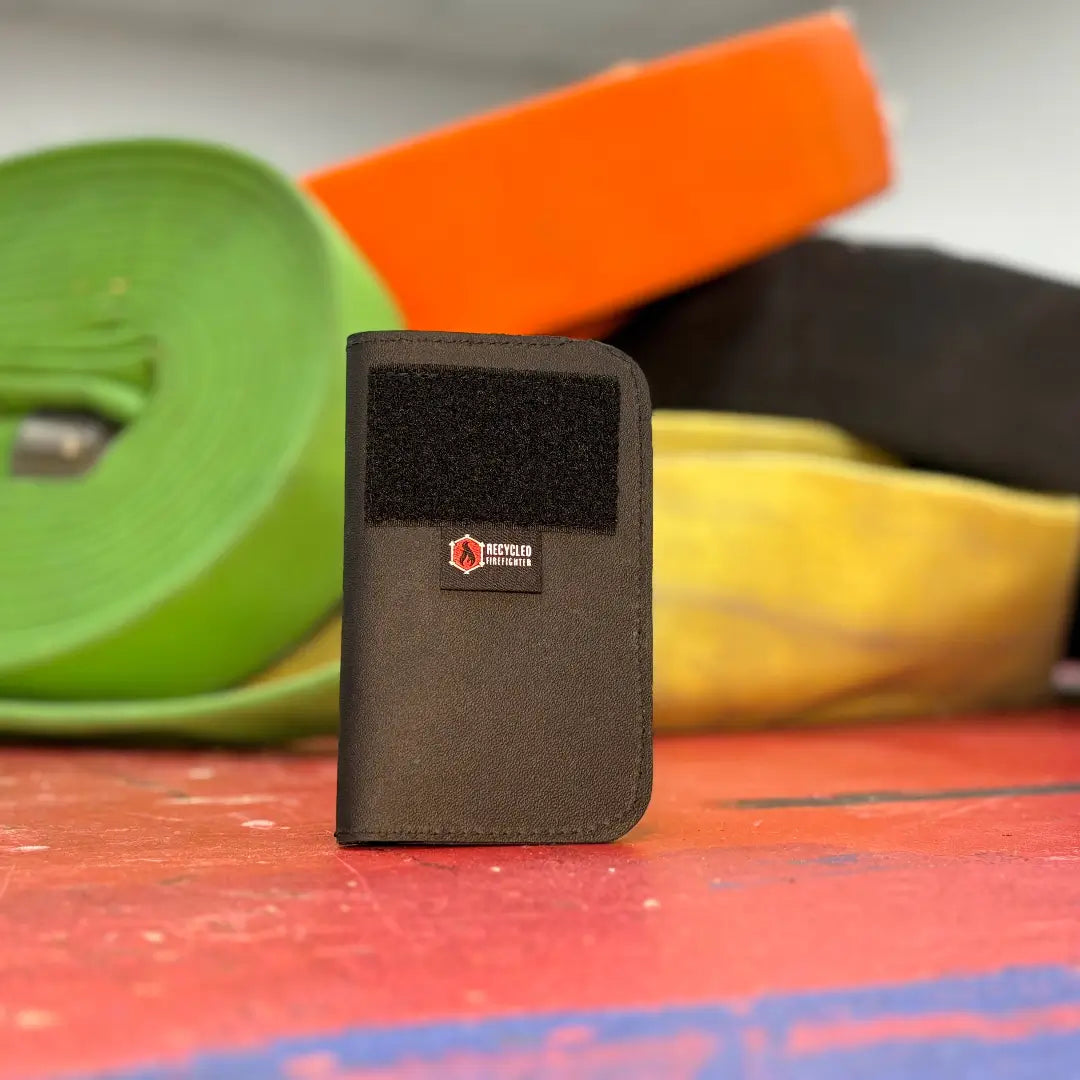 Black leather Field Notes Wallet by Recycled Firefighter, compact and durable for everyday carry.