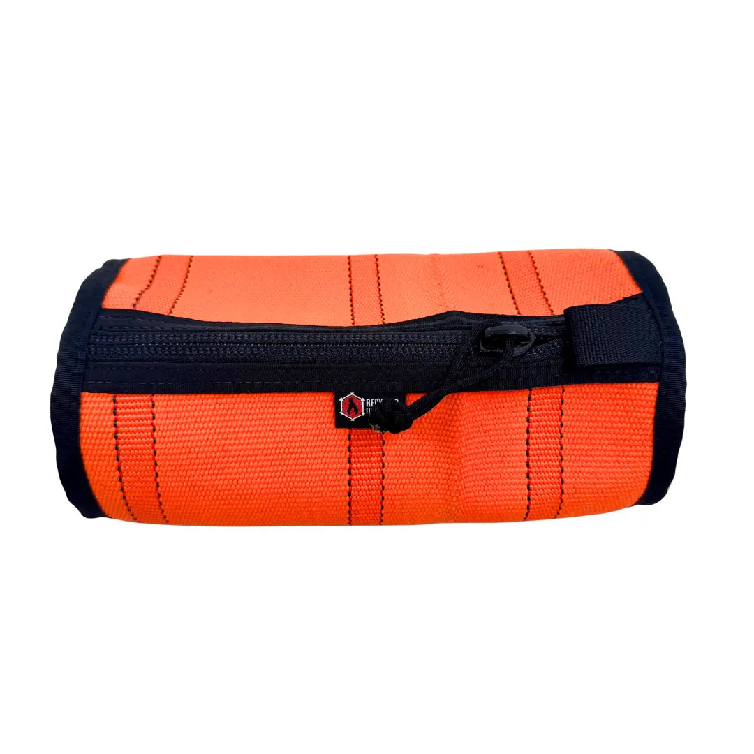 Orange Fire Hose Dopp Kit by Recycled Firefighter, durable travel toiletry bag made from recycled fire hose material.