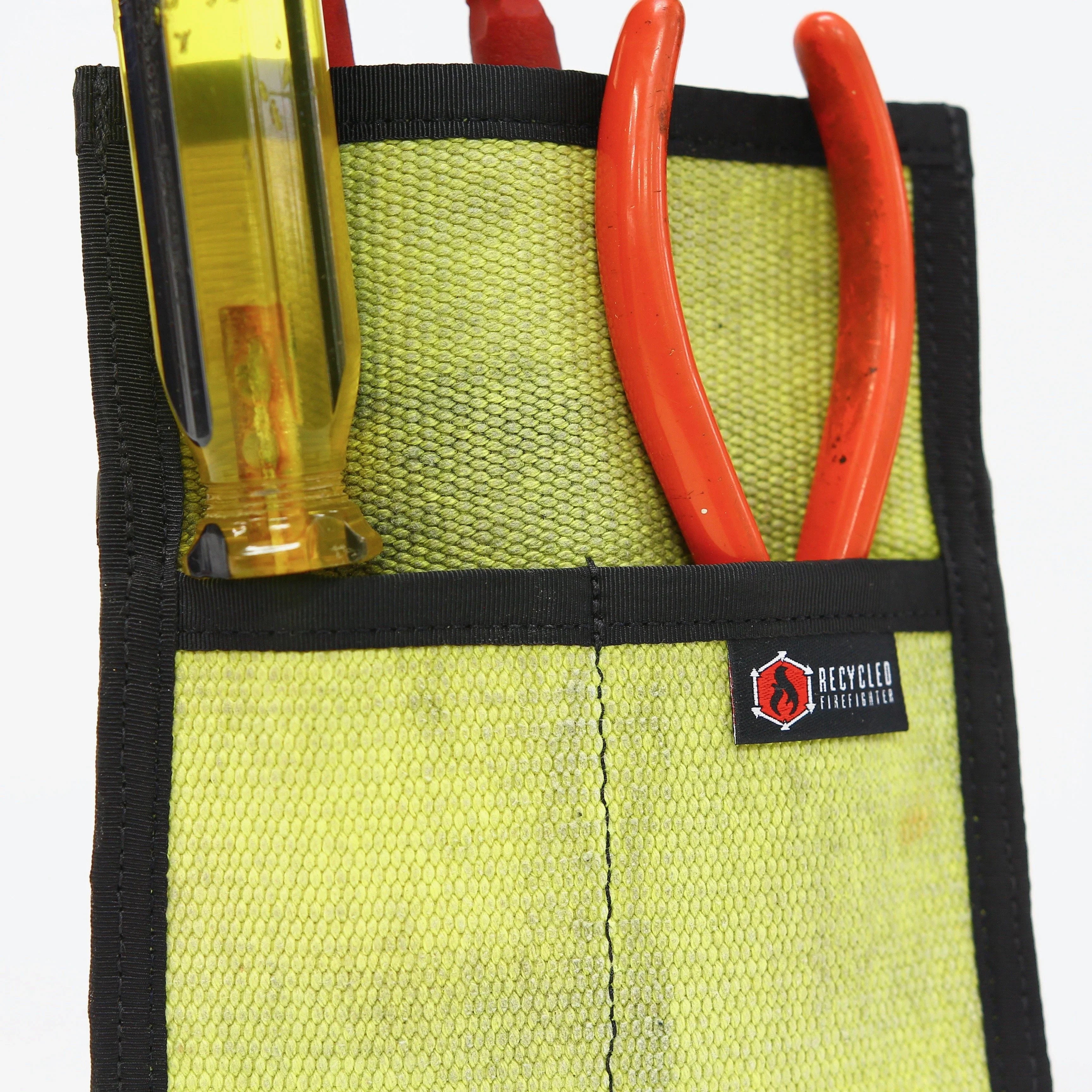 Recycled Firefighter fire hose tool pouch with multiple pockets and durable design, ideal for storing tools and gear.