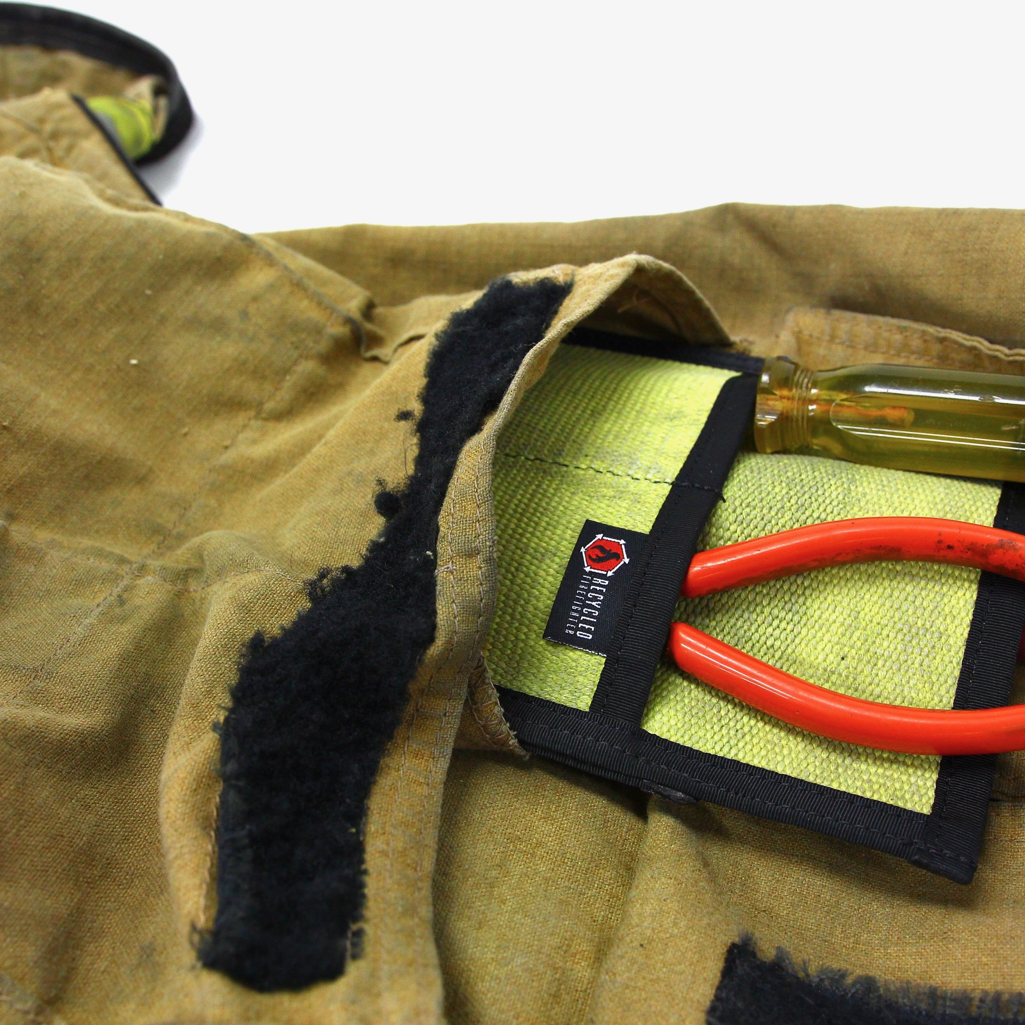 Recycled Firefighter fire hose tool pouch with durable construction and multiple pockets for essential tools.