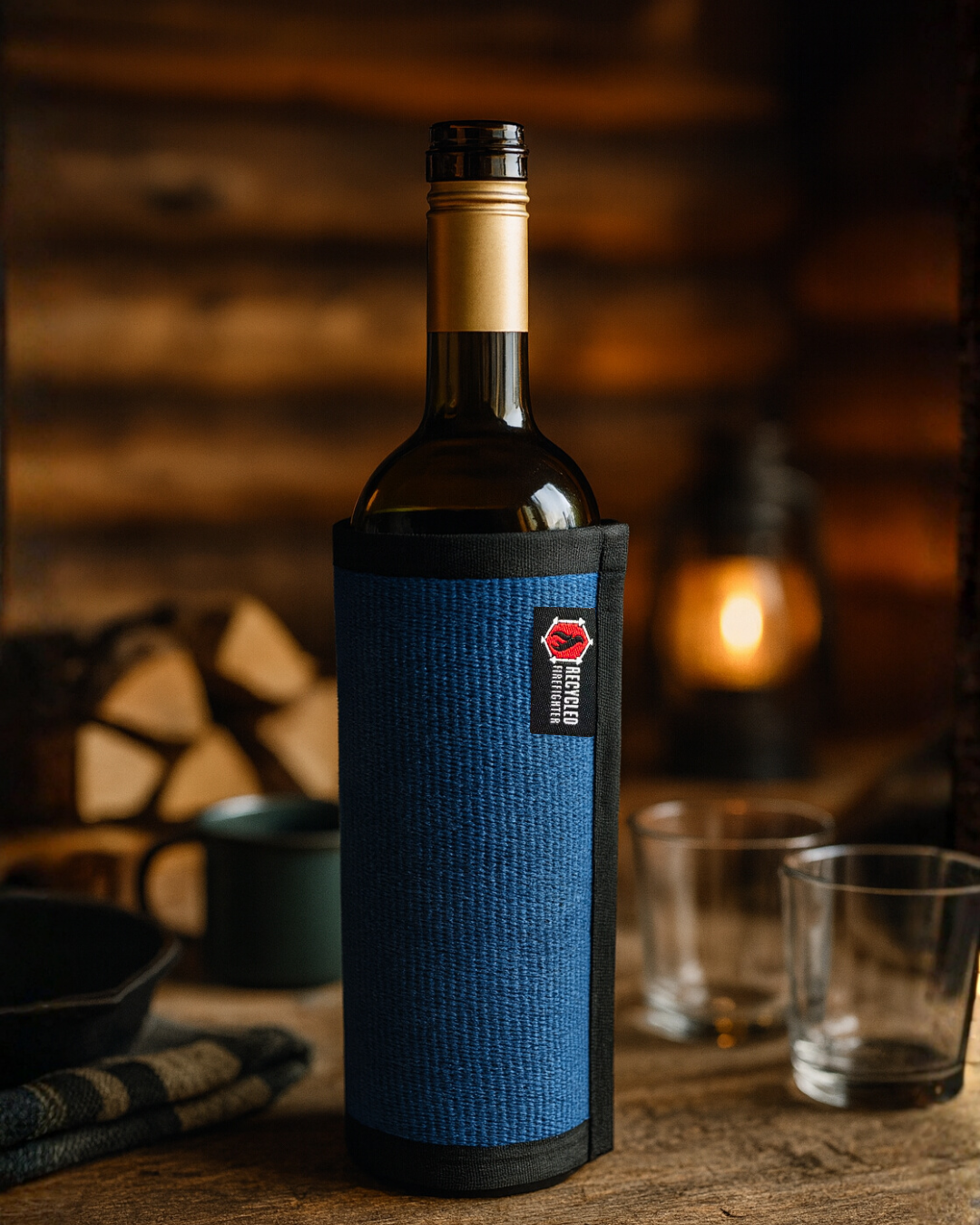 Blue firehose wine bottle cover by Recycled Firefighter, made from recycled firefighter hoses for a unique wine gift presentation.