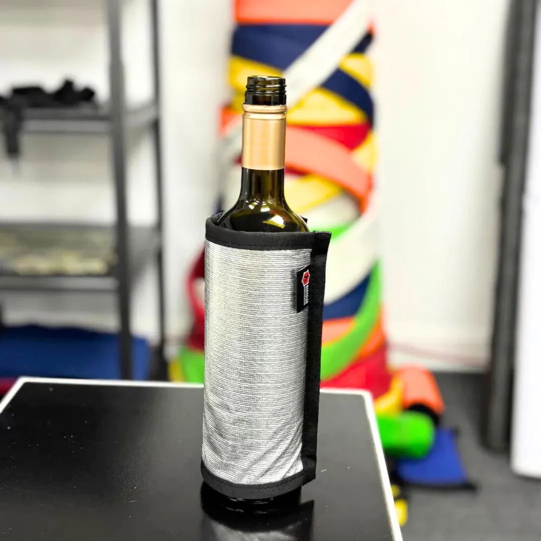 Silver Firehose Wine Bottle Cover by Recycled Firefighter, made from recycled firehose material, designed to protect and decorate wine bottles.