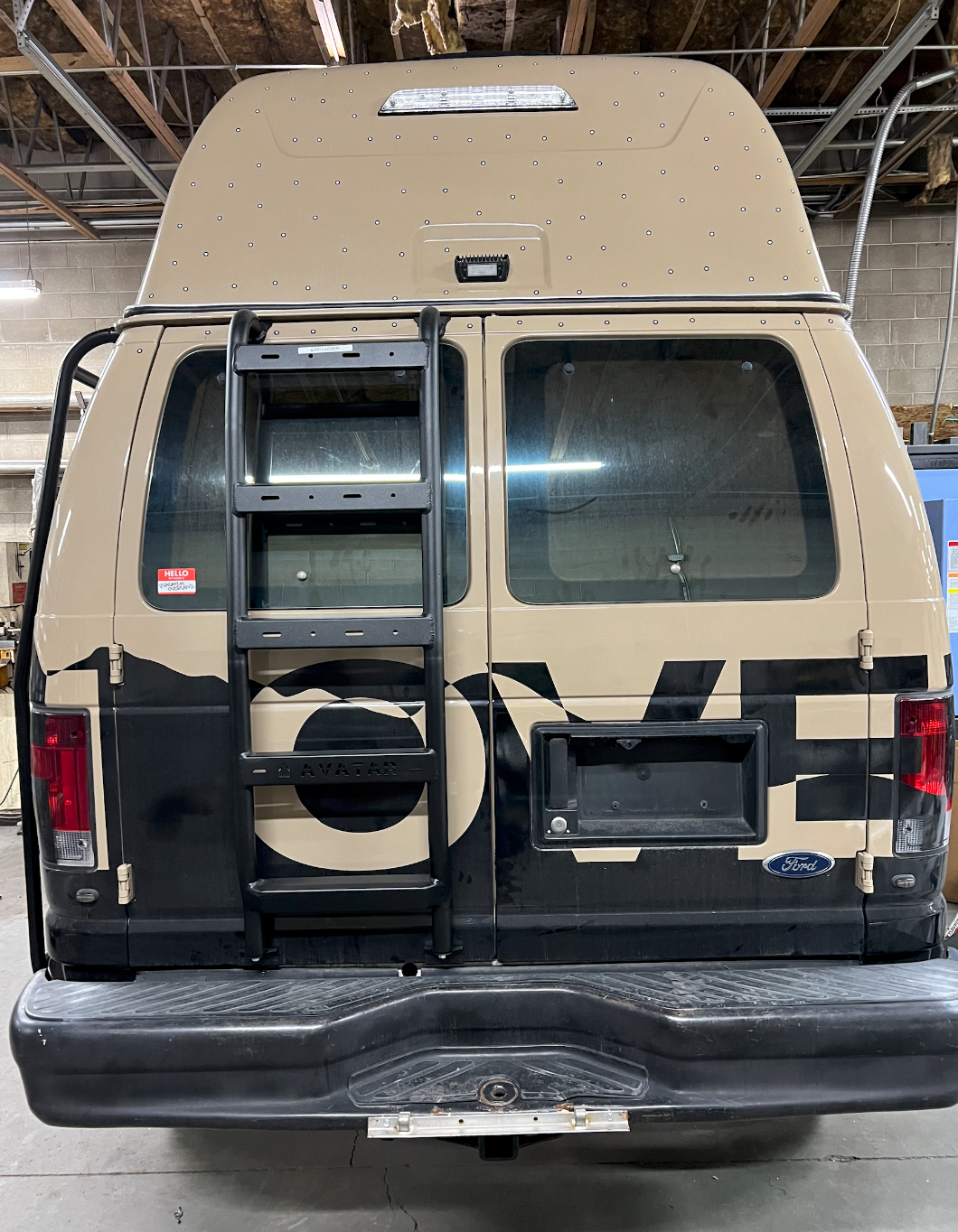 Avatar Offroad Ford E-Series rear ladder mounted on the back of a vehicle for easy roof access.