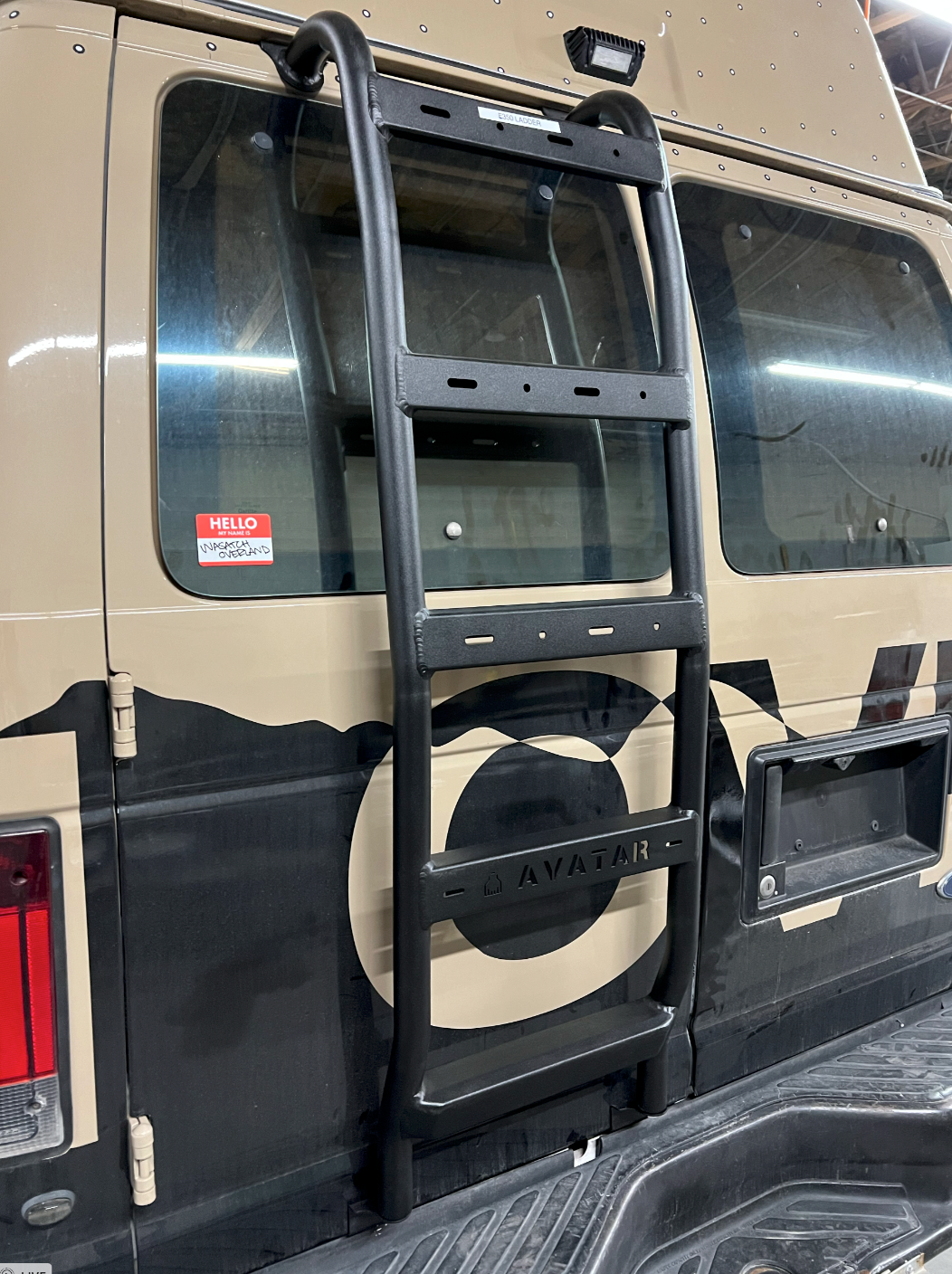 Avatar Offroad Ford E-Series rear ladder mounted on the back of the truck for easy access to the roof or cargo area.