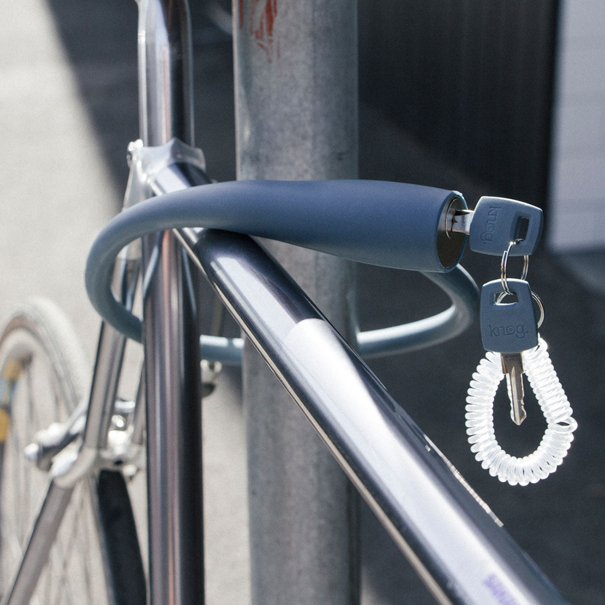 Knog Frankie Cable Lock by ZEITBIKE, featuring a compact black lock with a flexible cable for bike security.