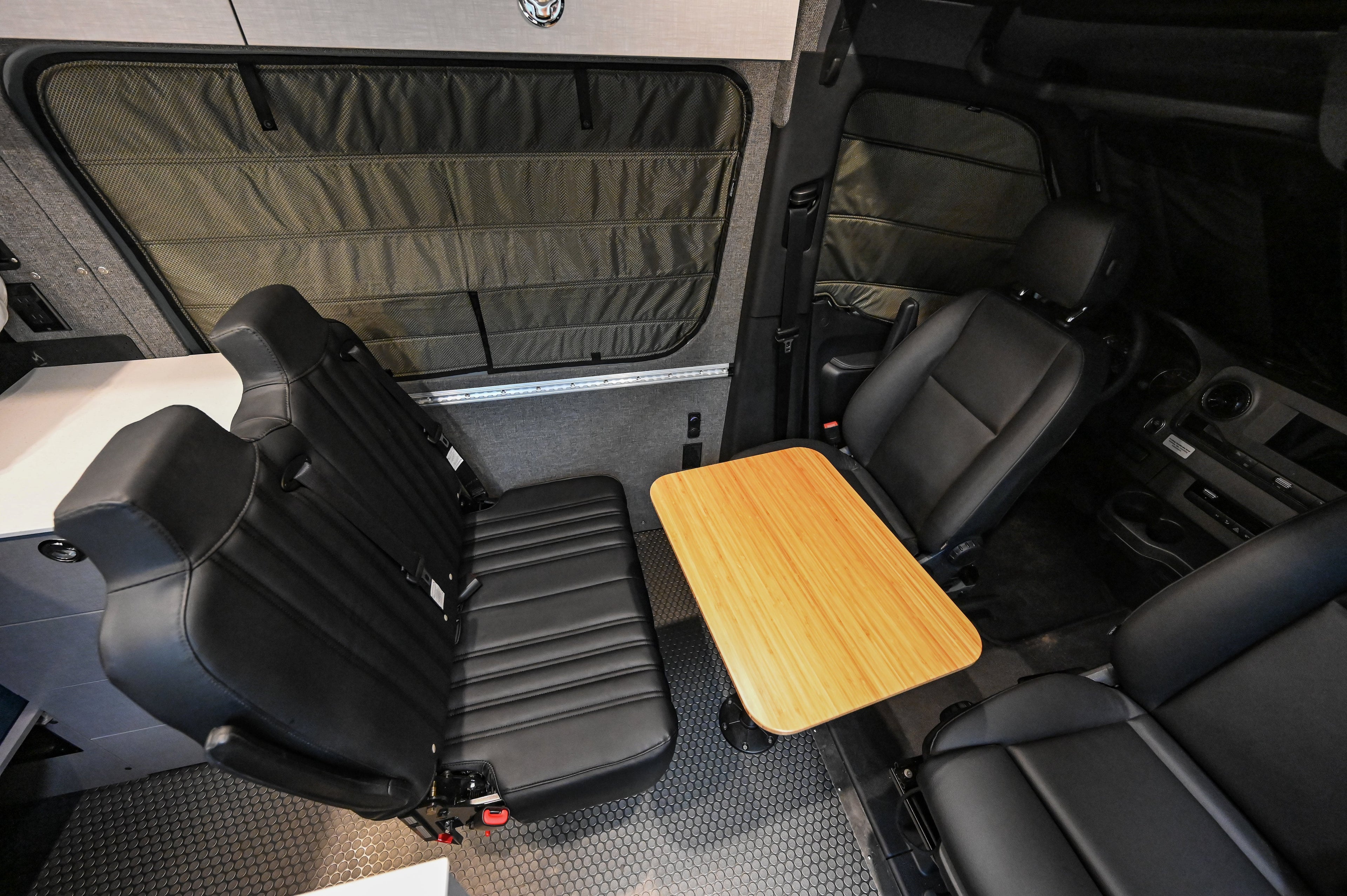 Alpine Van Works Hide N' Go Seat, versatile seating solution with foldable design, shown in a compact, portable position.
