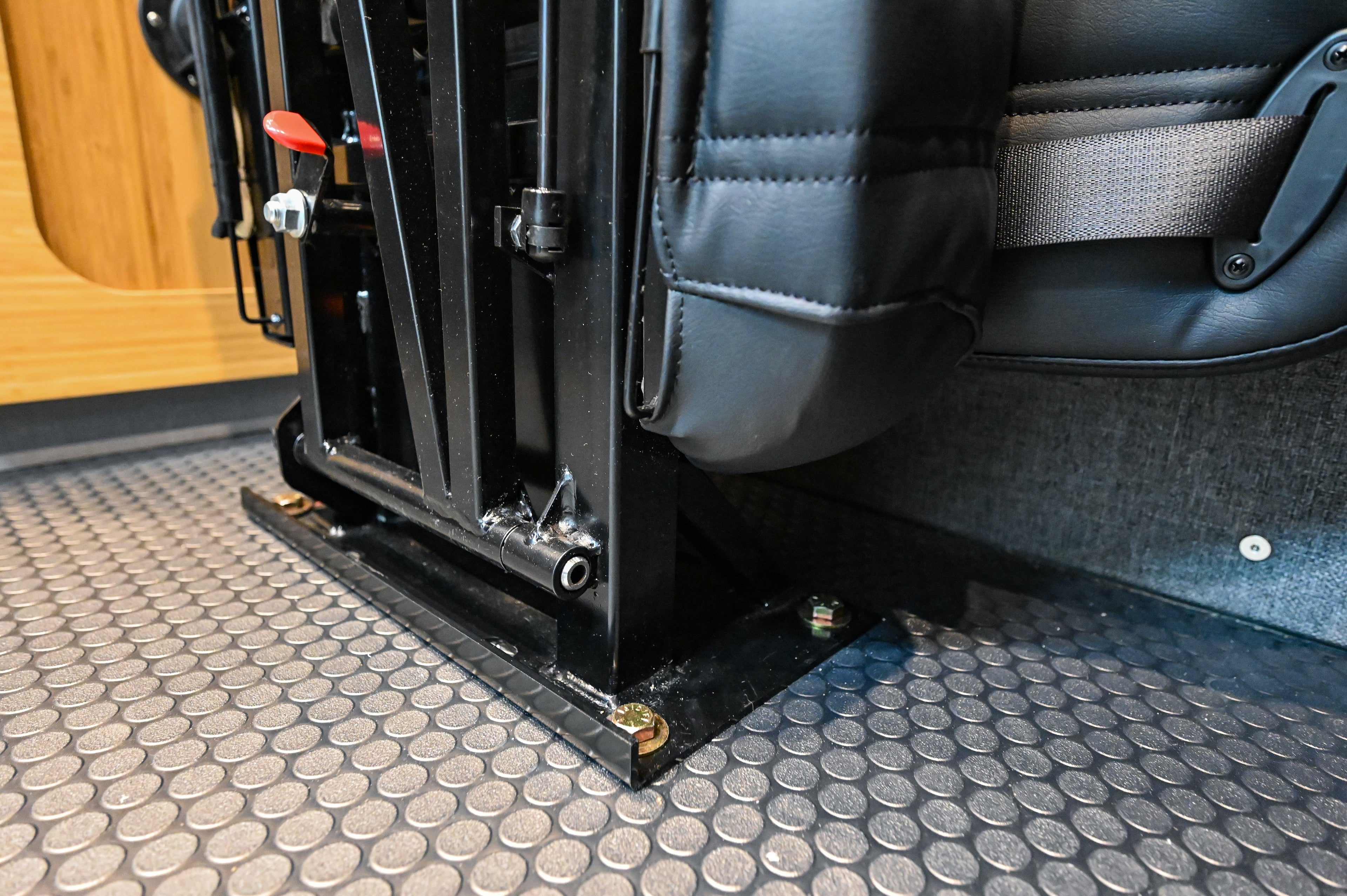 Alpine Van Works Hide N' Go Seat, versatile seating solution with foldable design, shown in a vehicle interior setting.
