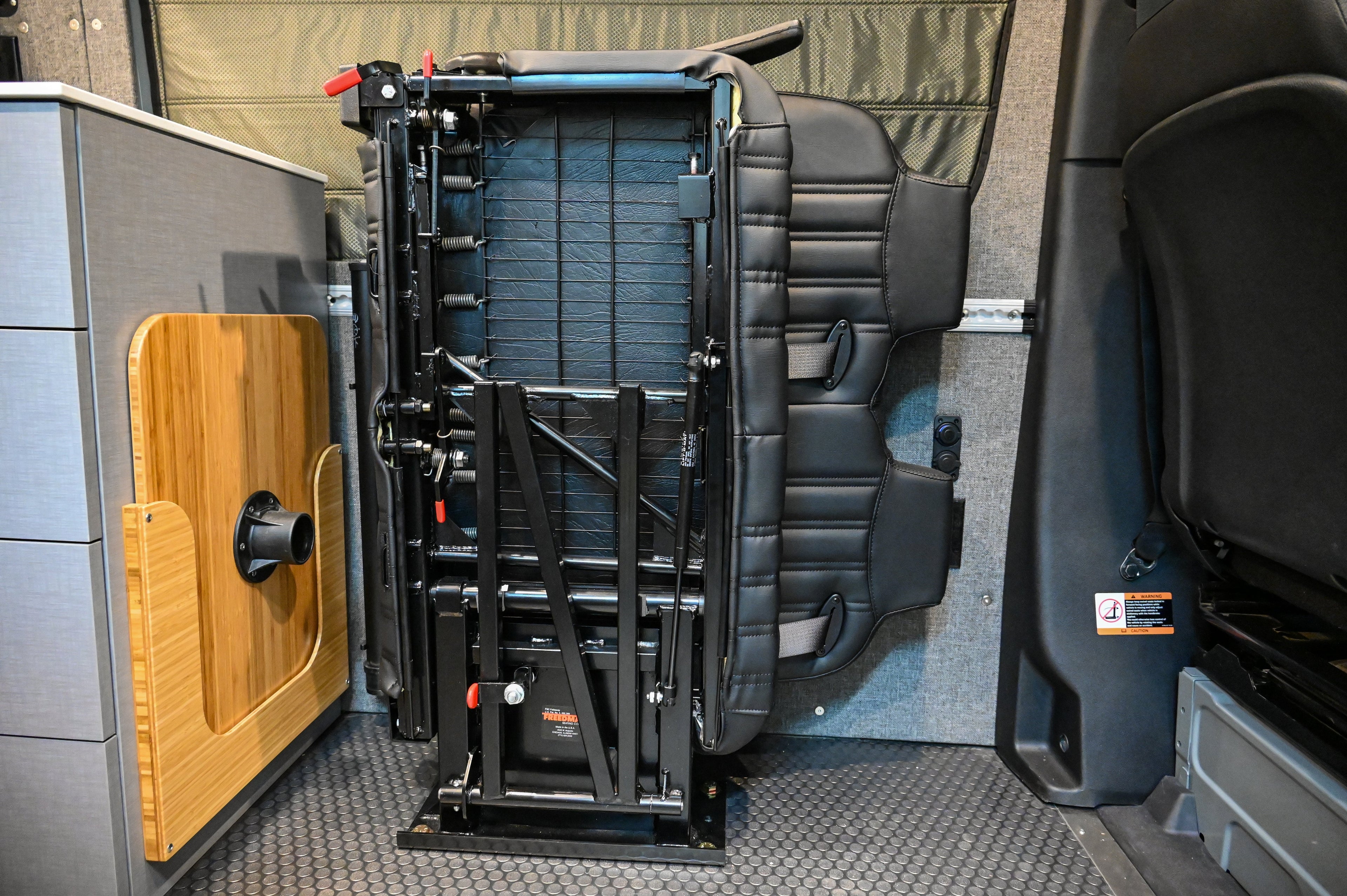 Alpine Van Works Hide N' Go Seat, a versatile seating solution with foldable design for vans and vehicles.