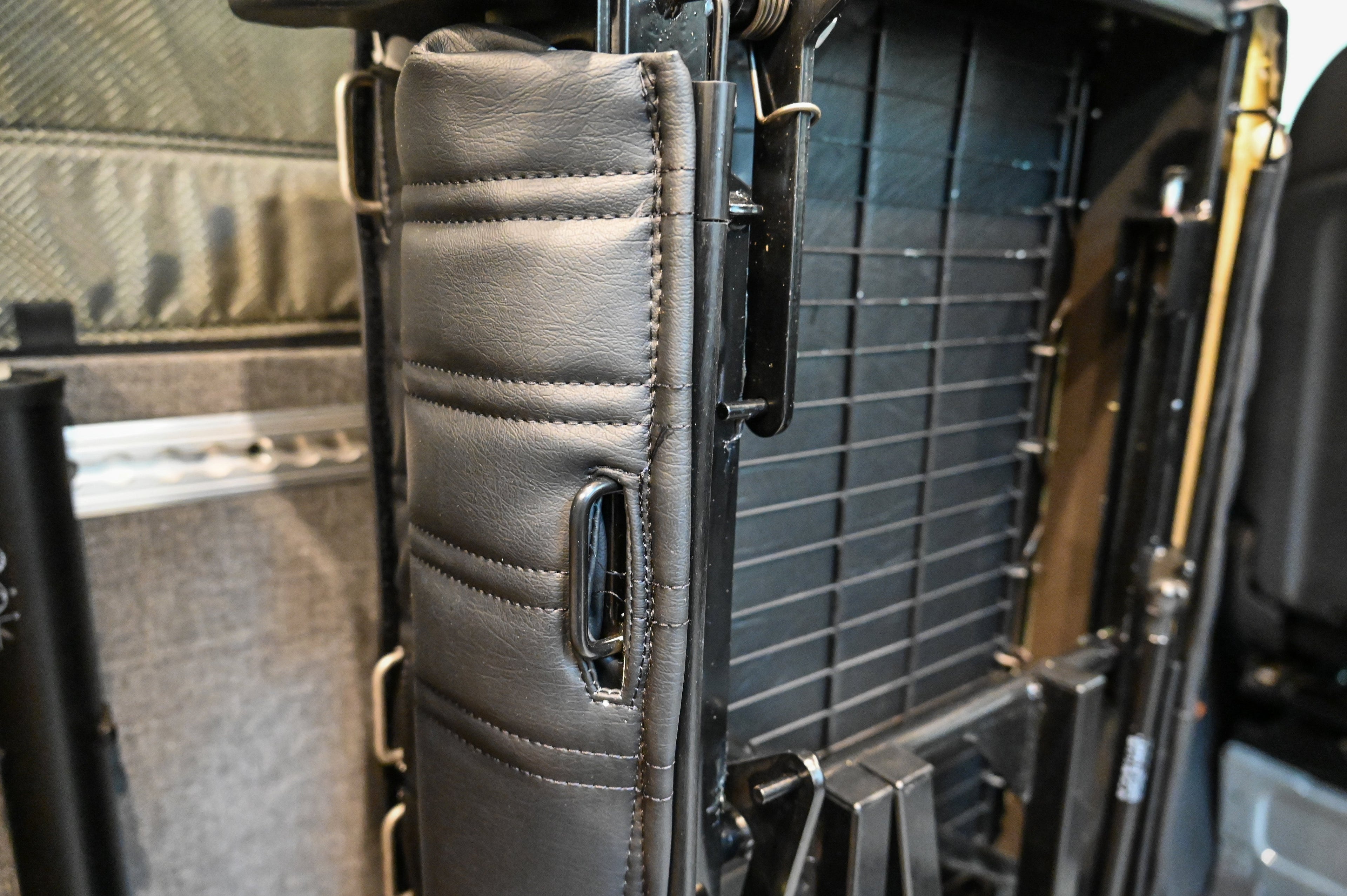 Alpine Van Works Hide N' Go Seat seating solution with foldable design, shown in a vehicle interior for versatile seating options.