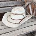 Ariat two-toned straw hat with a wide brim, showcasing a stylish design perfect for sunny outdoor activities.