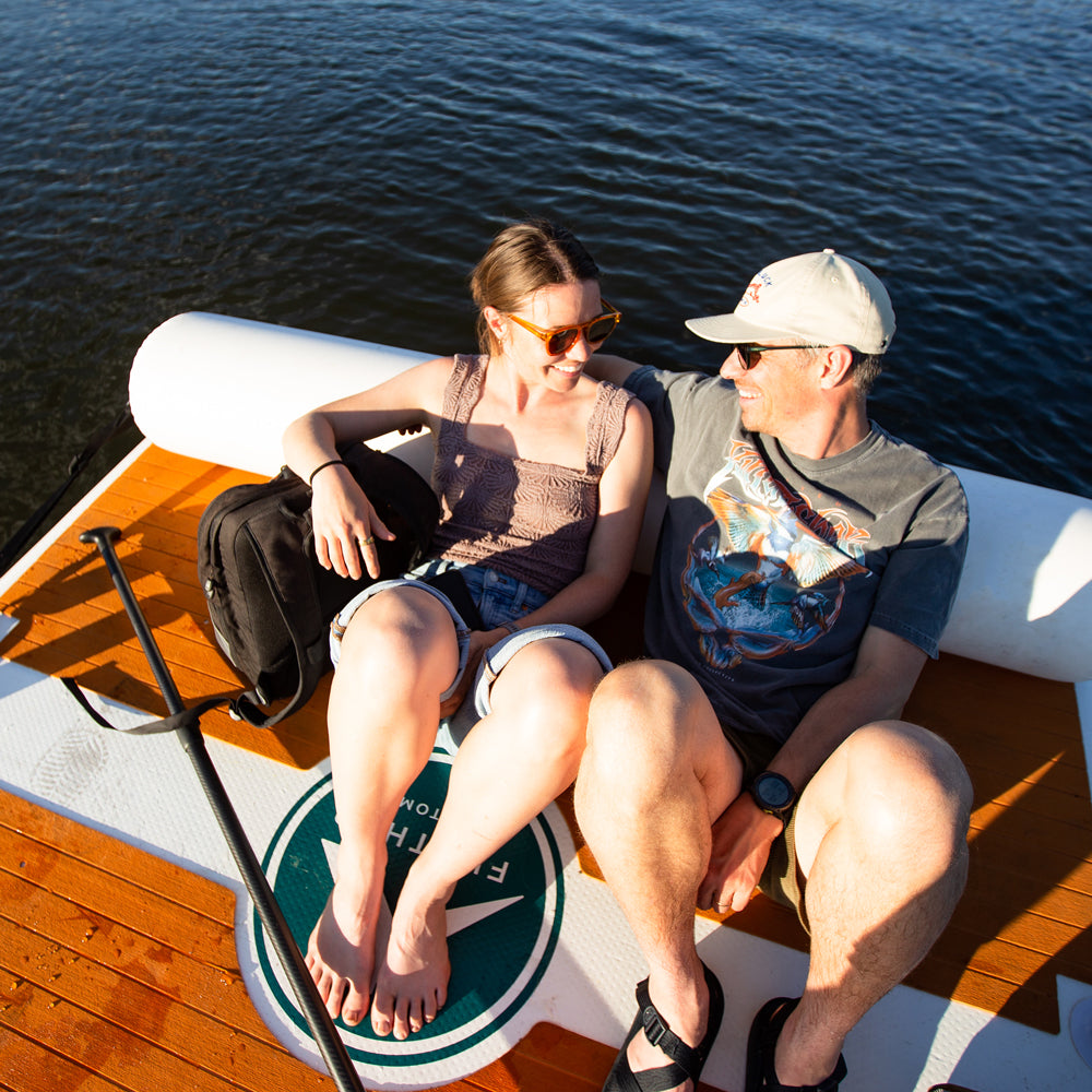 Inflatable Avalon Dock by Further Customs with swim step and backrest, floating platform for water recreation.