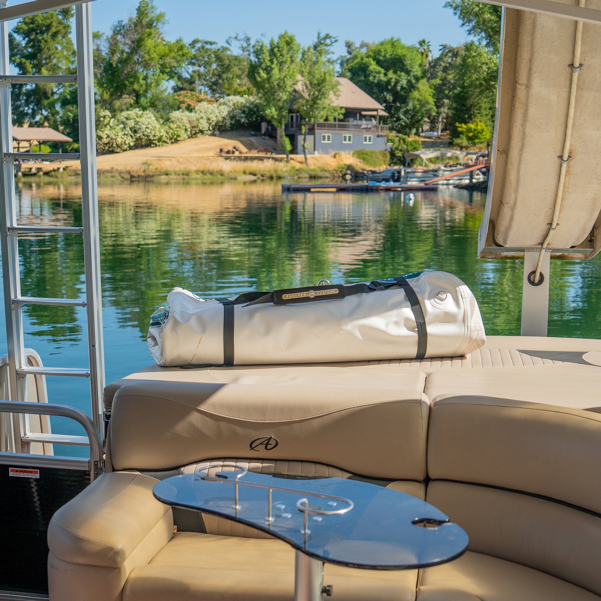 Further Customs Avalon Dock inflatable swim platform folded and deflated, stored on boat for easy deployment and versatile water recreation.