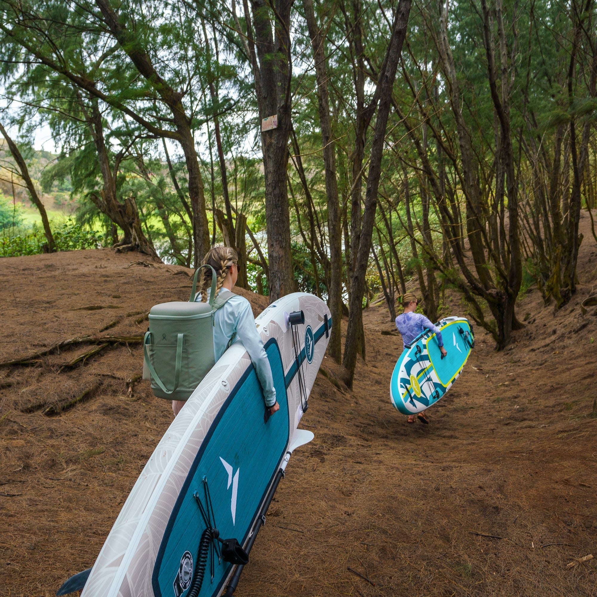 11'0 Further Customs Avalon Emerald paddleboard on the water, showcasing its sleek design and vibrant emerald color.