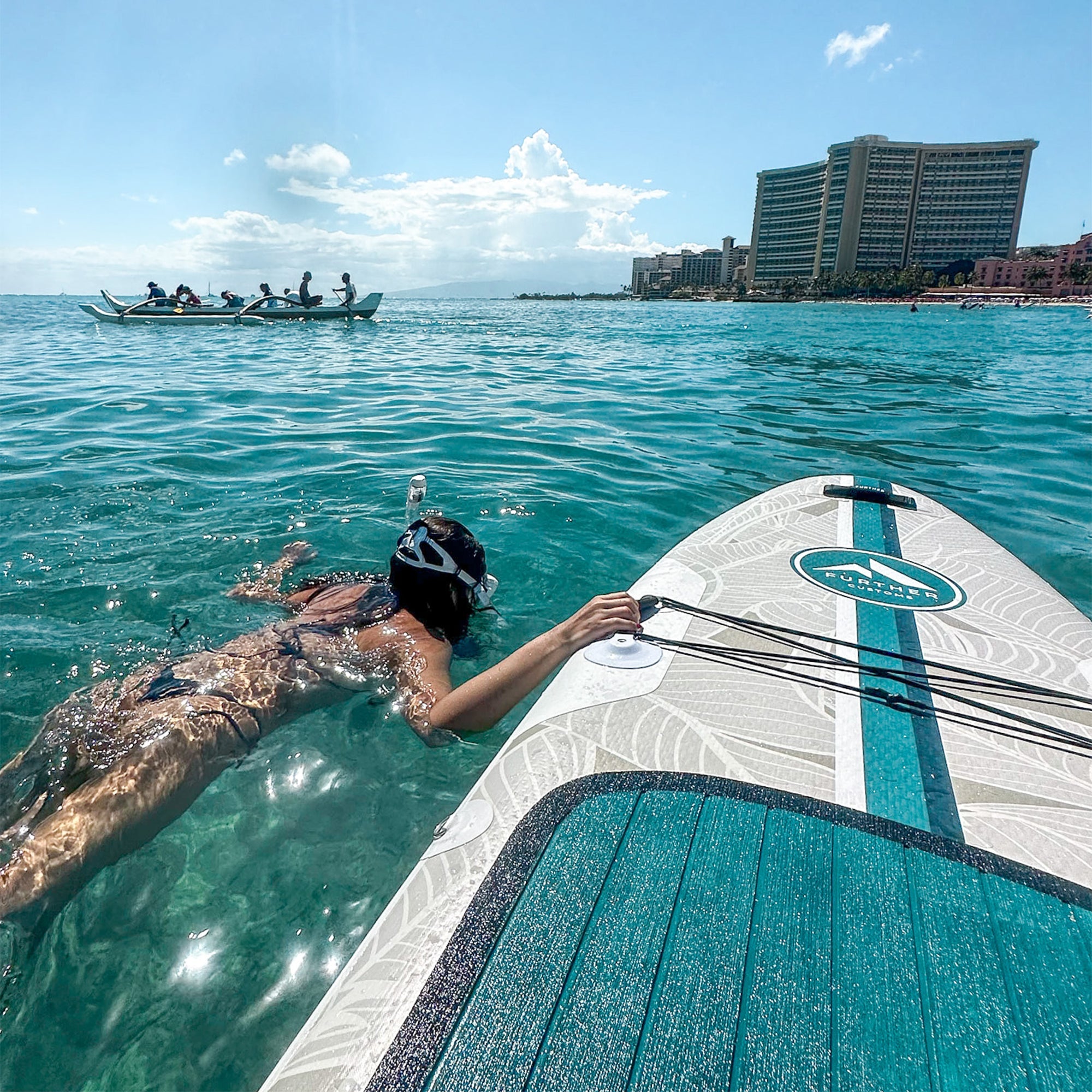 11'0 Avalon Emerald paddleboard by Further Customs, featuring a vibrant green design against a scenic Waikiki backdrop.