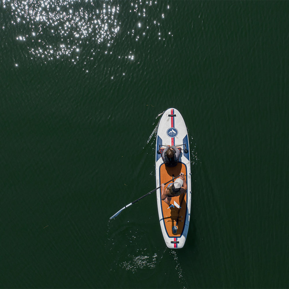 Two riders on the Further Customs Avalon Mariner 11'0 paddleboard viewed from above. Durable paddleboard designed for stability and fun.