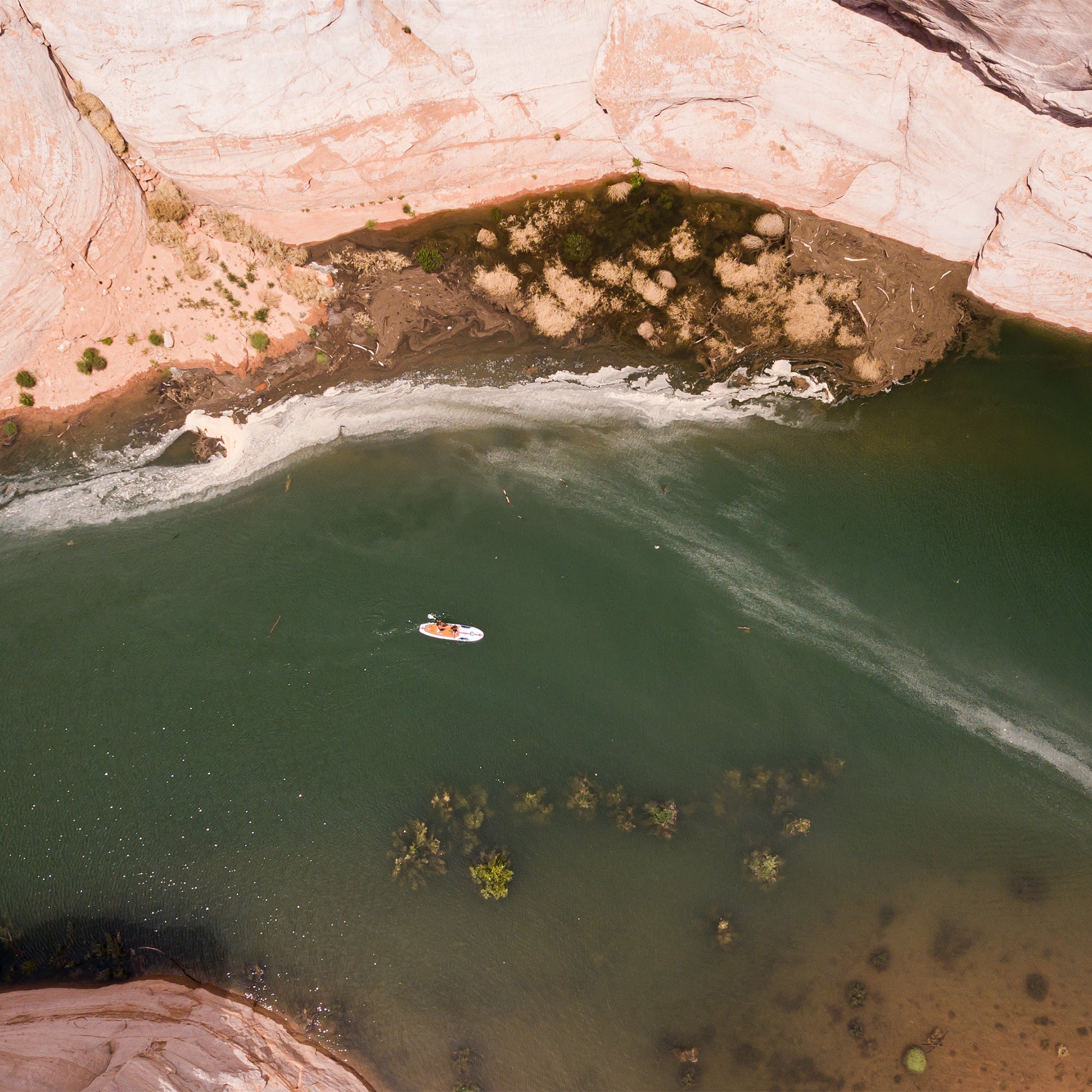 Top view of a 11'0 Avalon Mariner paddleboard by Further Customs on Utah Lake Powell, showcasing its sleek design and deck features.