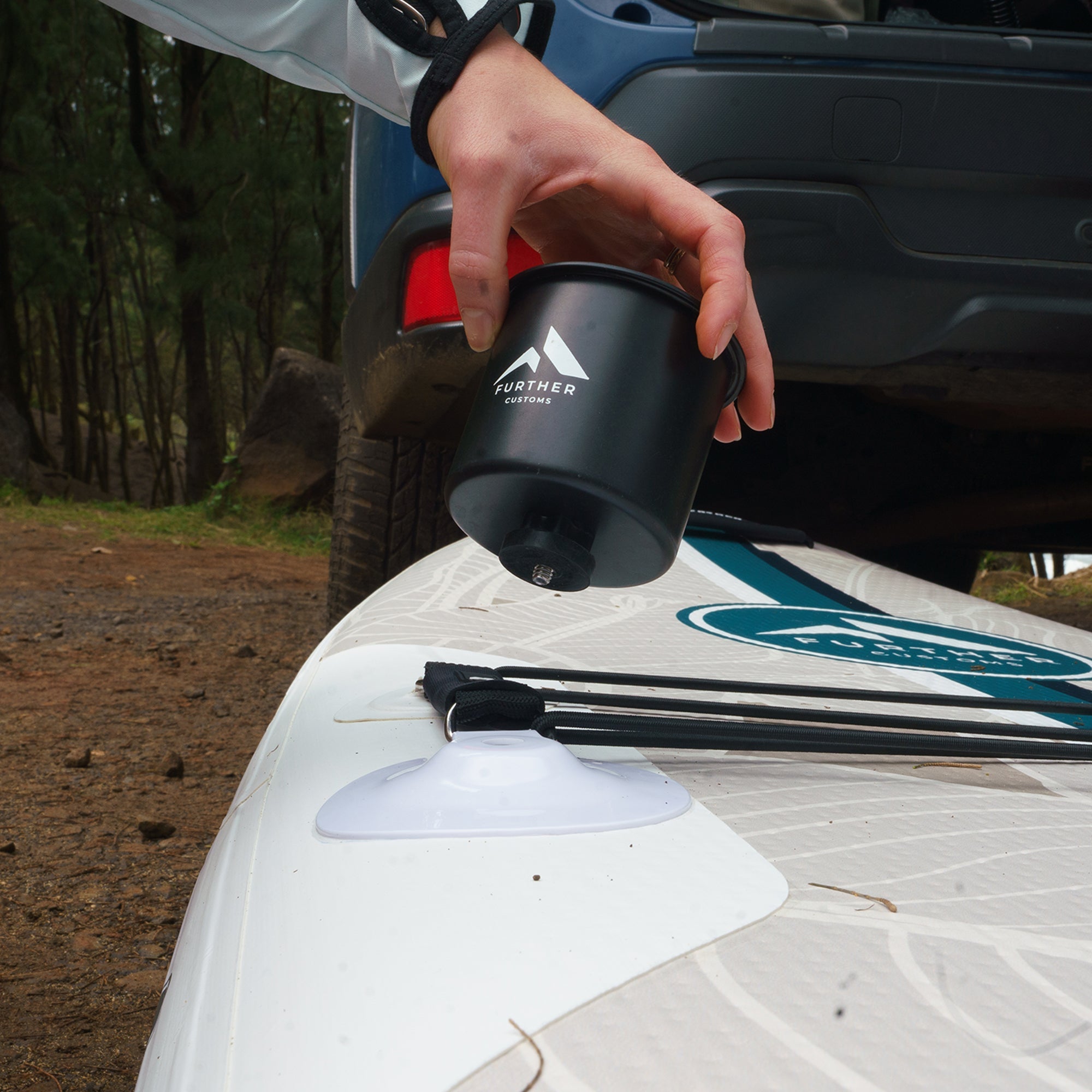 11'0 Avalon Emerald paddleboard by Further Customs featuring a sleek design and vibrant green color on a beach setting.