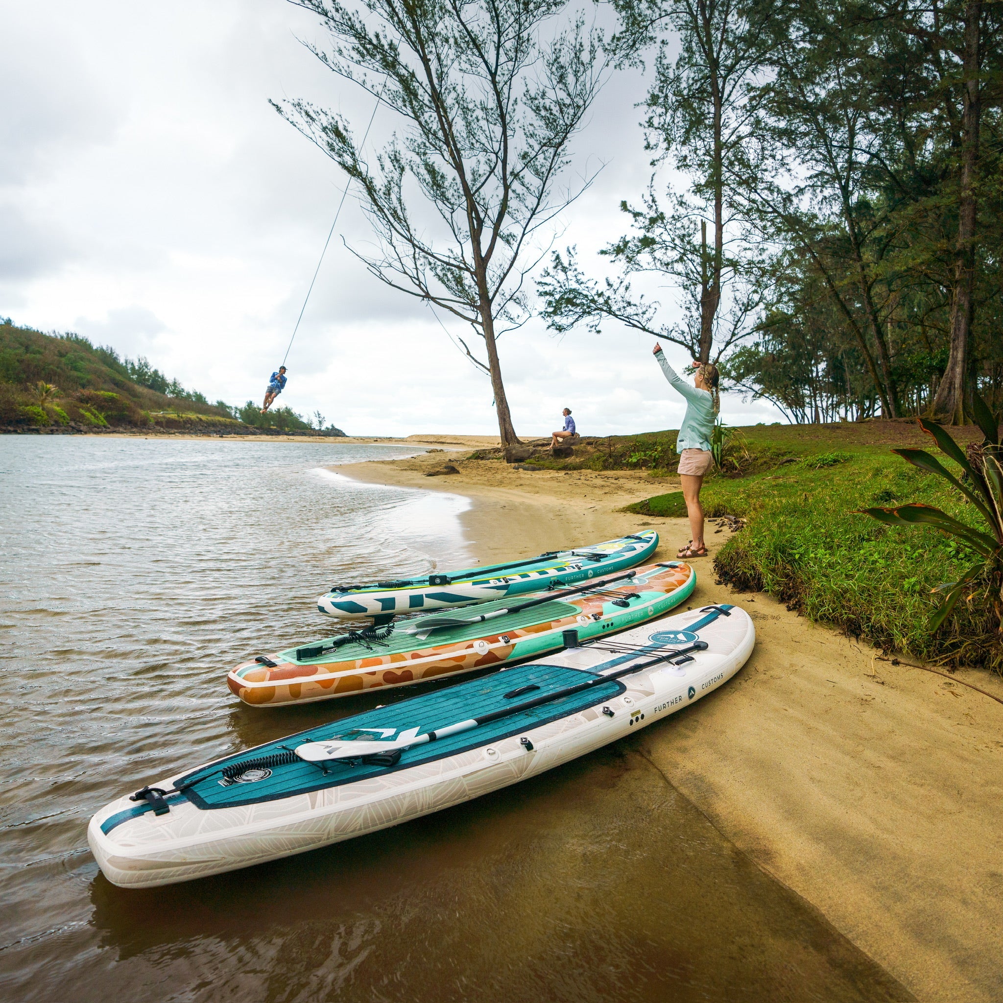 Inflatable paddleboard by Further Customs in Tamarack Sage color, featuring a sleek design perfect for water adventures.