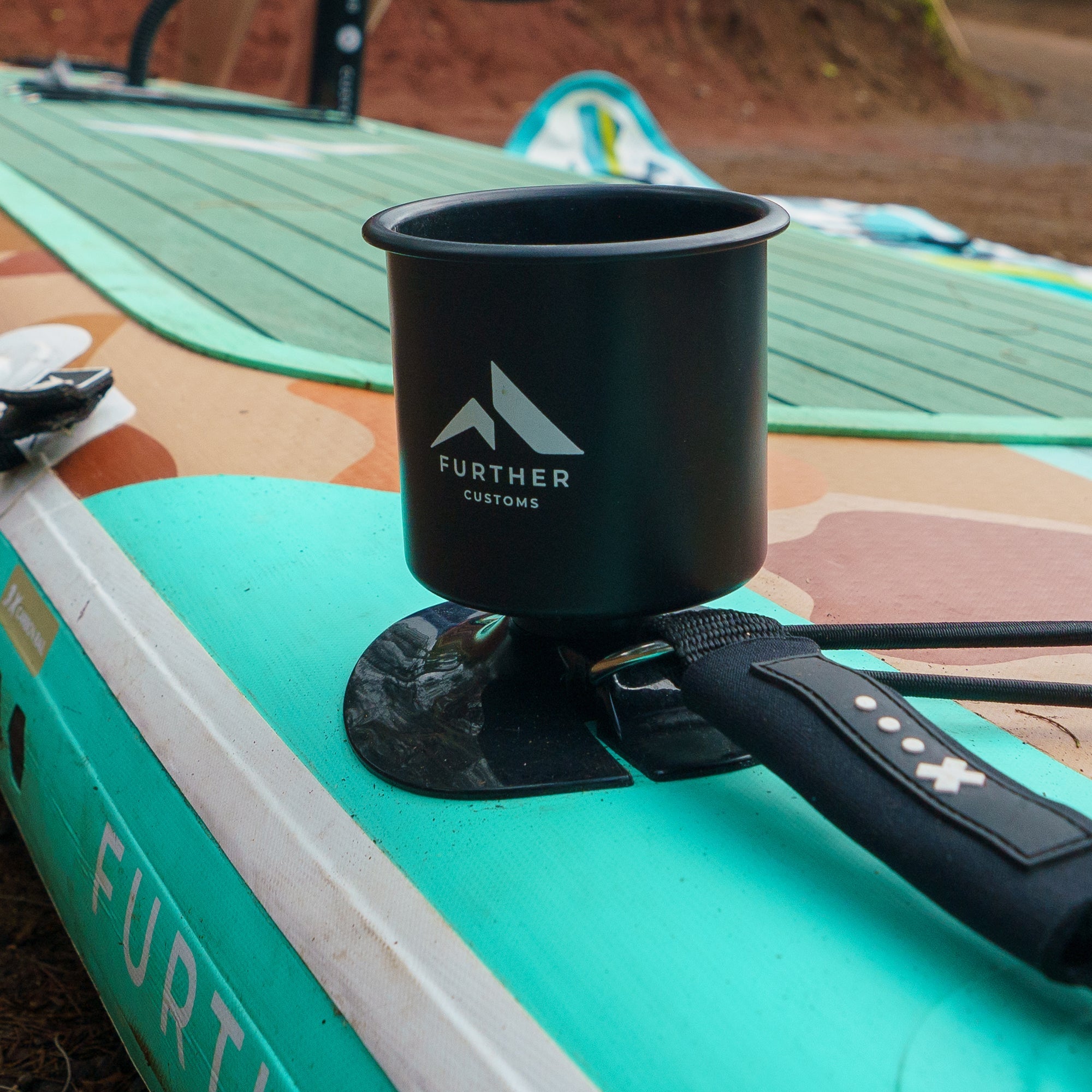 Further Customs 11'0 Tamarack Sage paddleboard with built-in cup holder, designed for stability and convenience on the water.