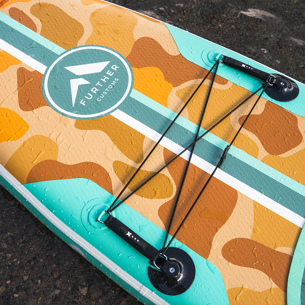 Close-up of a 11'0 Tamarack Sage paddleboard by Further Customs showcasing its textured surface and vibrant green color.