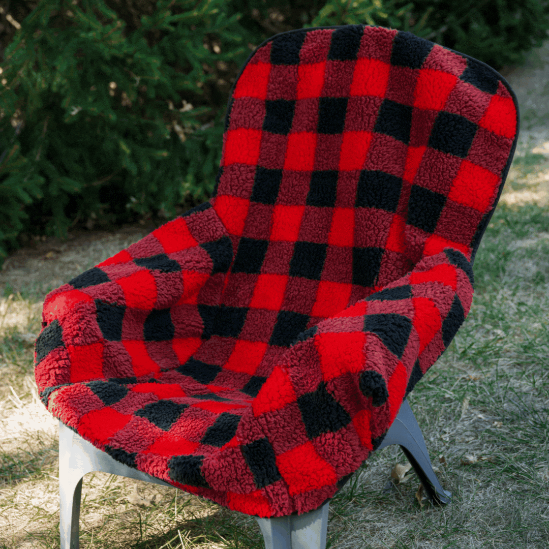 Cozy City Bonfires Chair Blanket draped over a chair, showcasing its soft fabric and inviting design.