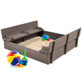 Grey cedar wood kids outdoor sandbox with built-in benches, sturdy garden furniture for outdoor play and relaxation.