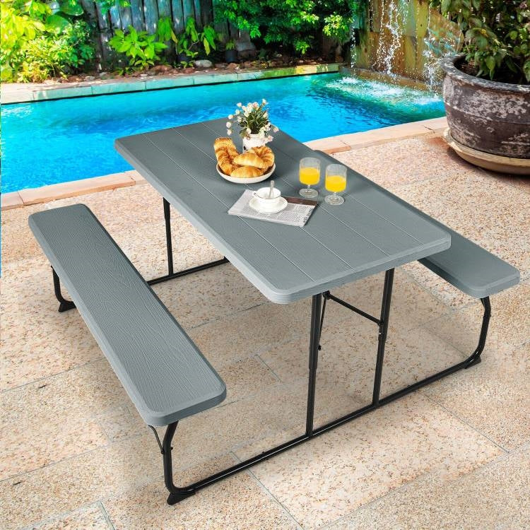 Grey folding picnic table with two benches, outdoor patio dining set by HomePacific, suitable for outdoor gatherings and family meals.