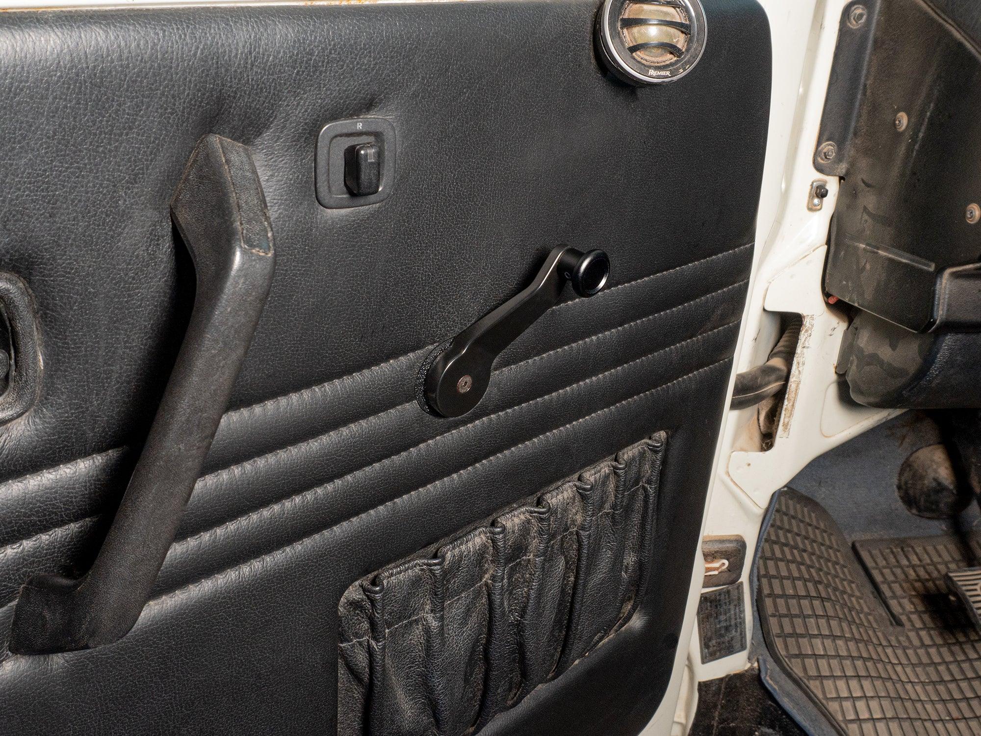 Heavy duty high offset window crank by GoWesty installed on vehicle window, featuring durable metal handle and black plastic base.