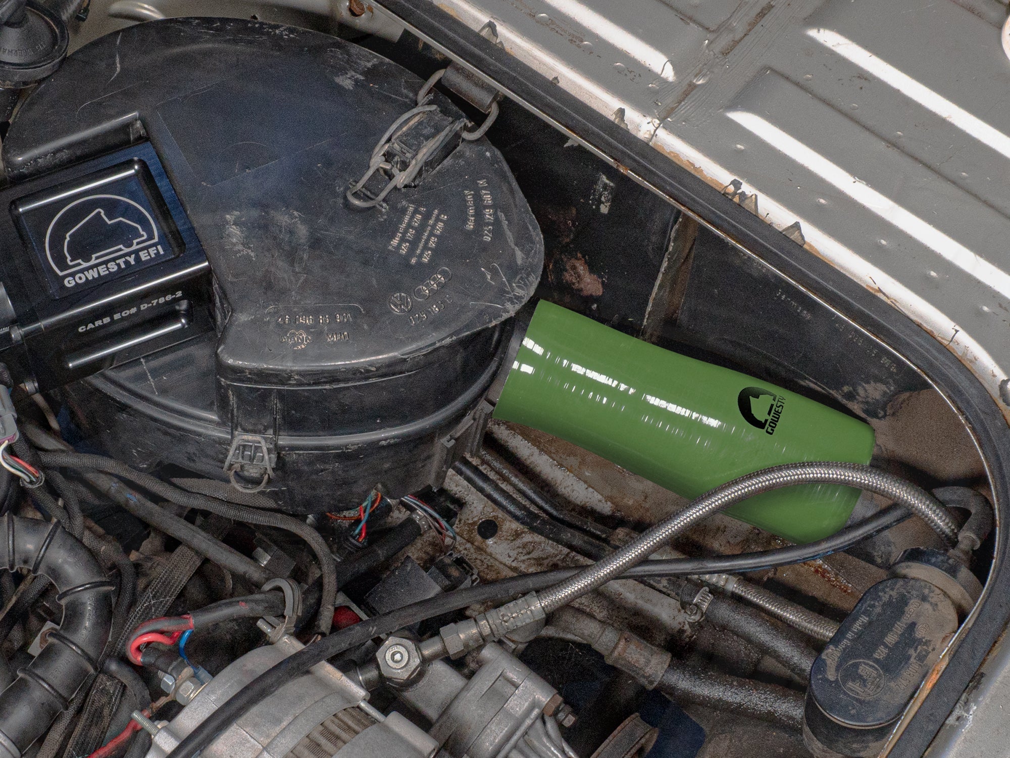 Green GoWesty air intake hose installed in a late Vanagon 2WD or Syncro engine, showcasing mechanical parts and fit.